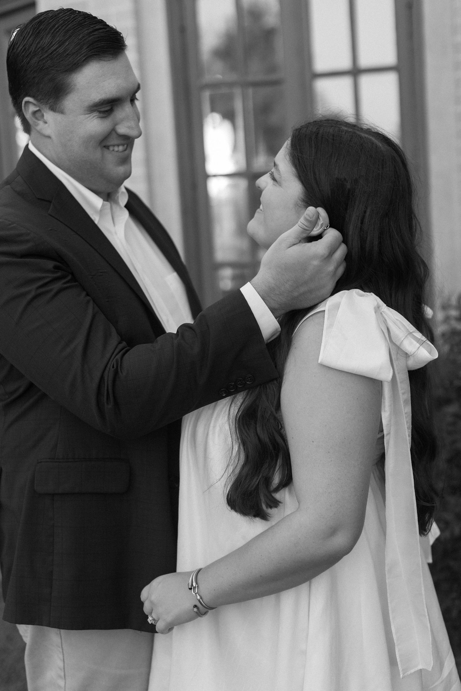 Black and white photo series of a couple sharing tender moments together in formal attire.