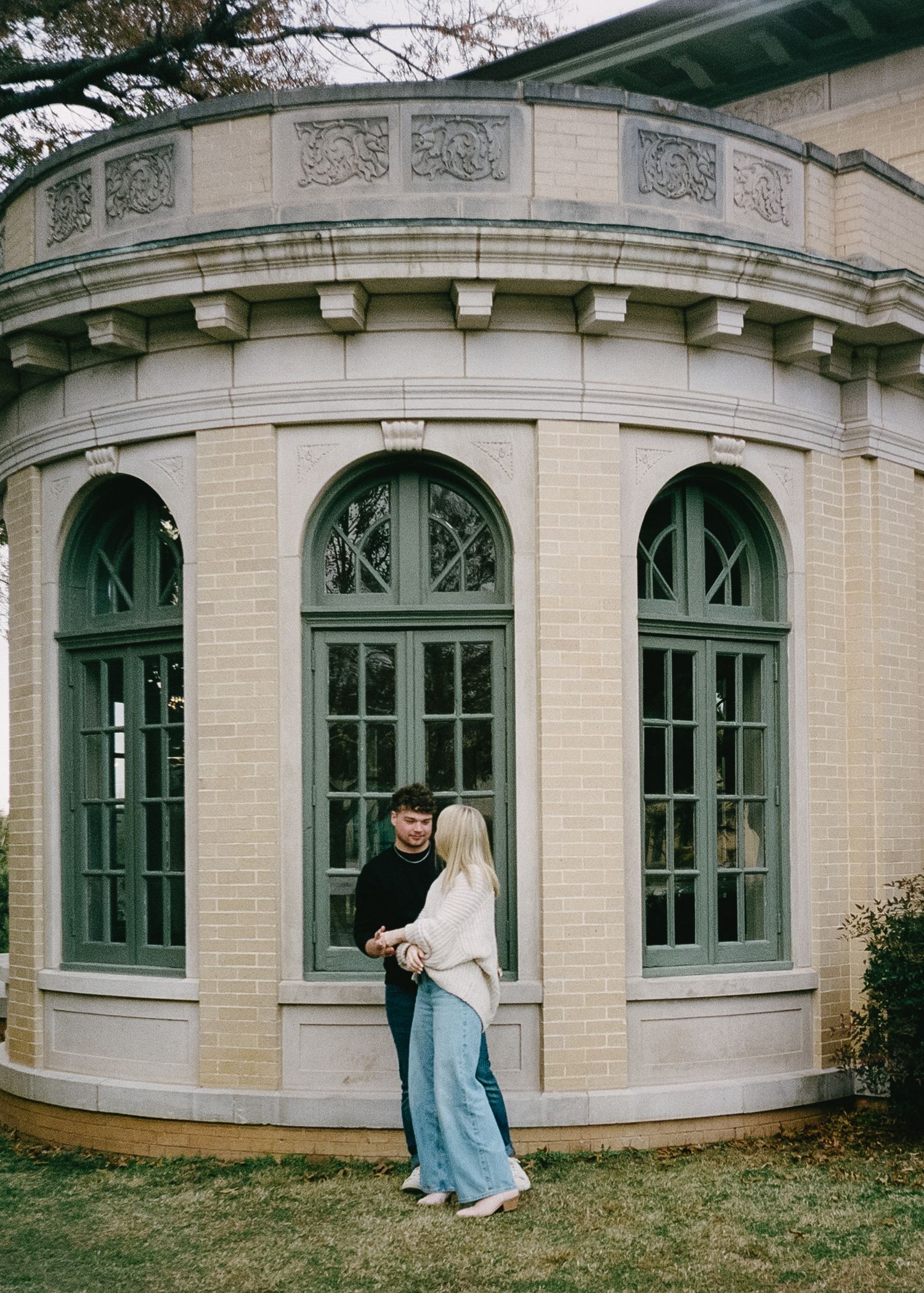 A curved architectural facade with arched windows and ornate stonework details photographed from multiple angles.