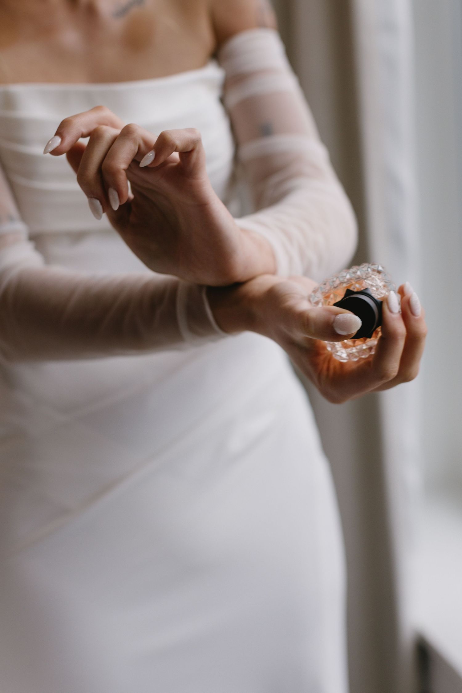 Close-up of hands holding a ring detail at an elegant wedding ceremony.