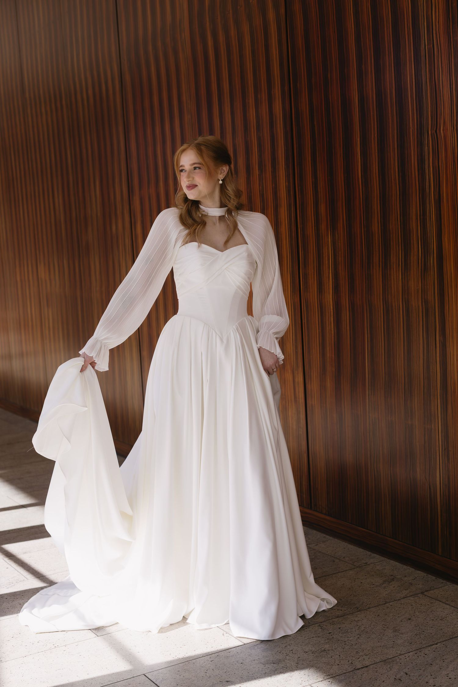 Elegant bridal portraits against wooden paneled walls with natural window lighting.