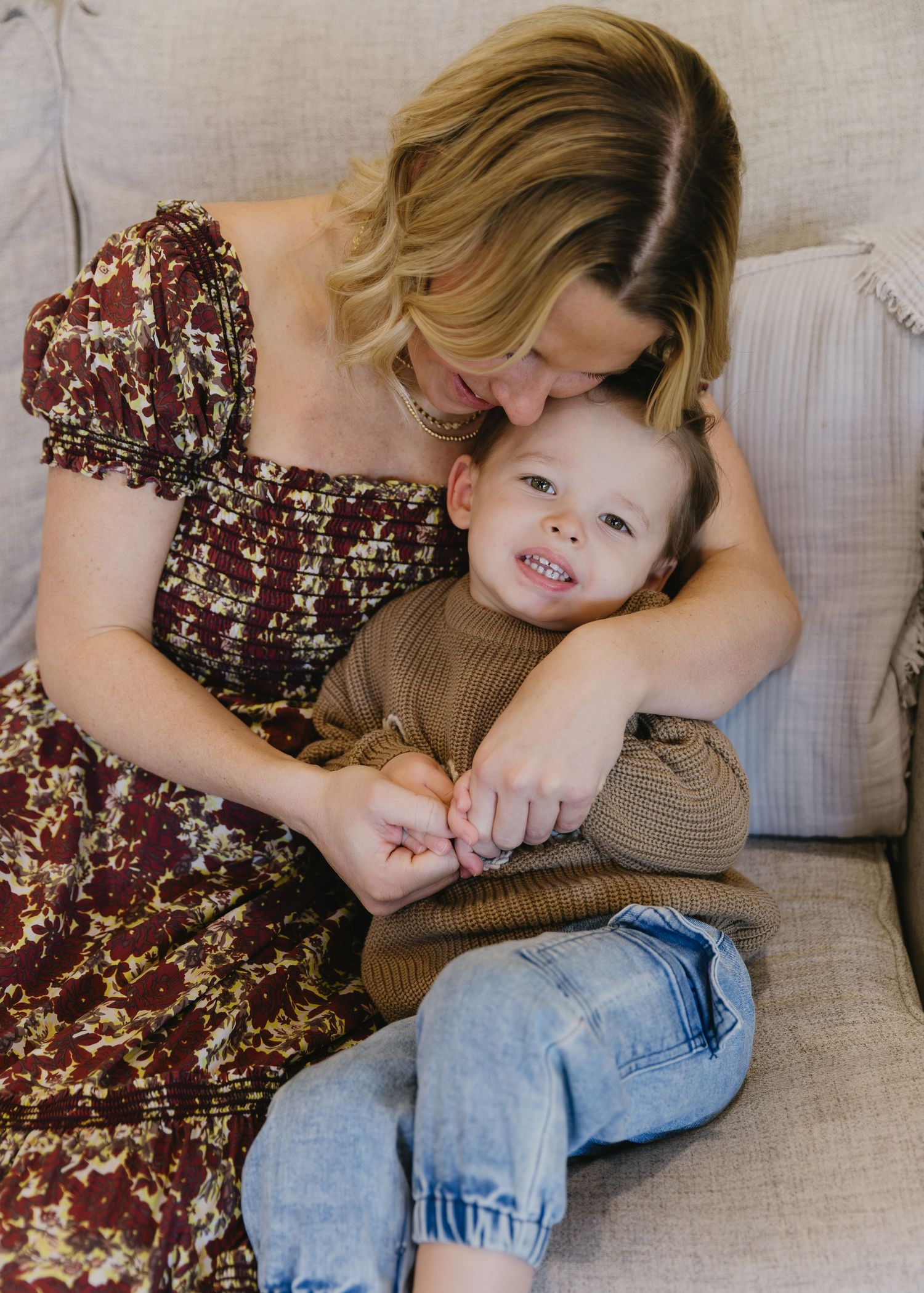 Intimate family moment on a couch showing cuddles and embraces.