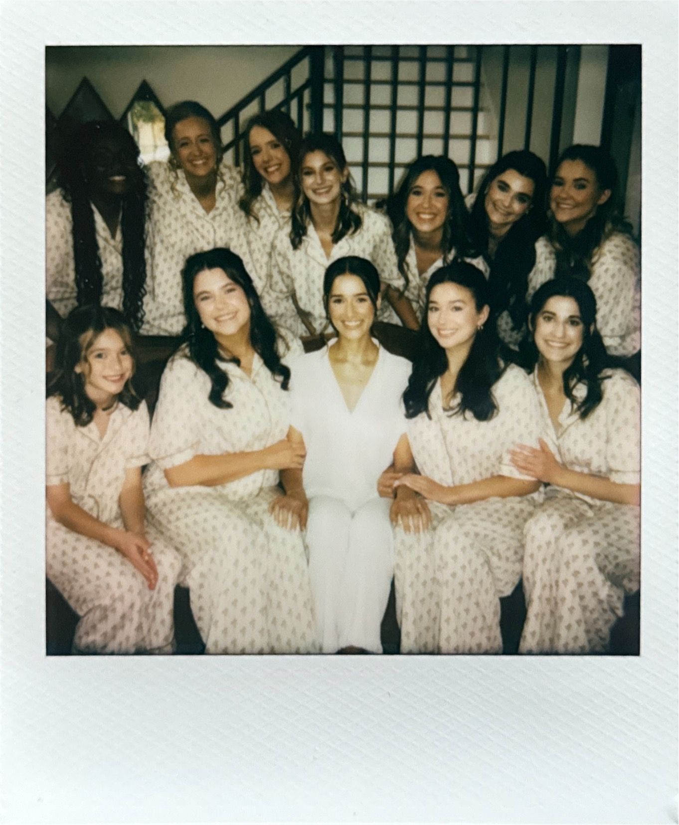 Group wearing matching floral robes pose together in vintage-style polaroid photos.