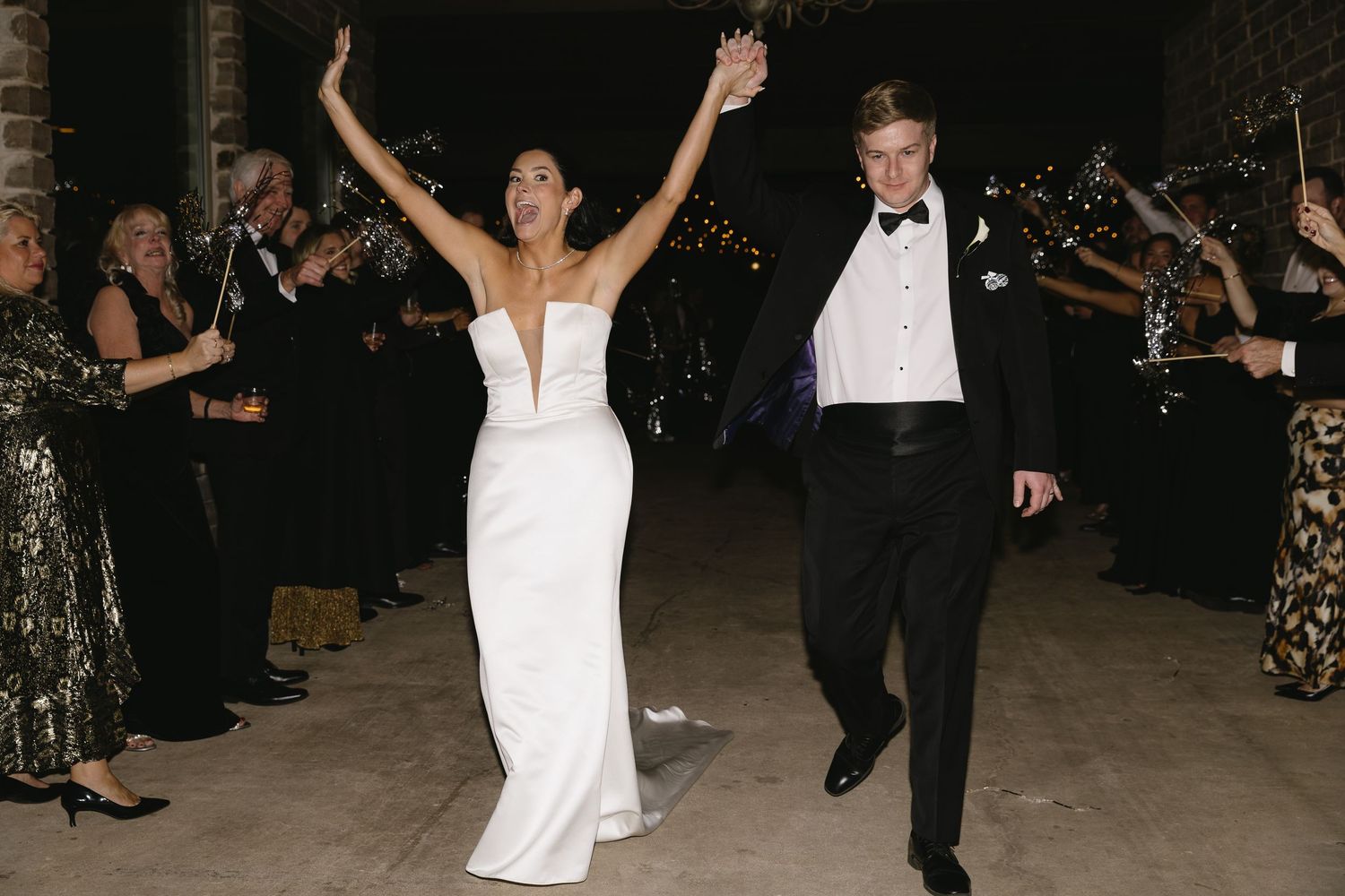 Wedding reception dance floor with guests celebrating in formal attire.