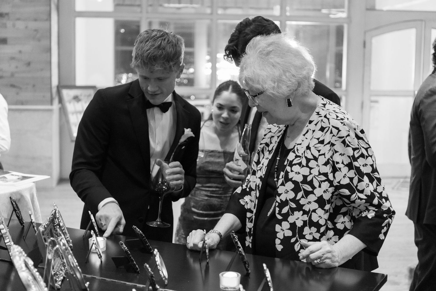 Wedding guests mingle and socialize at tables during an elegant reception.