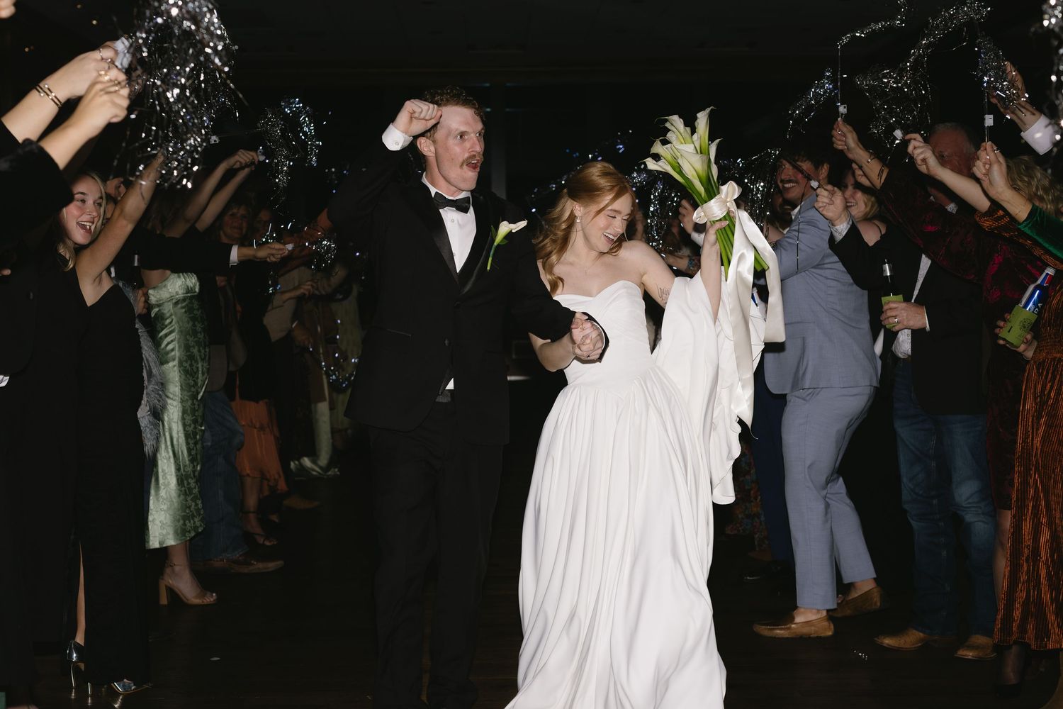 Wedding celebration at night with sparklers creating a magical atmosphere.