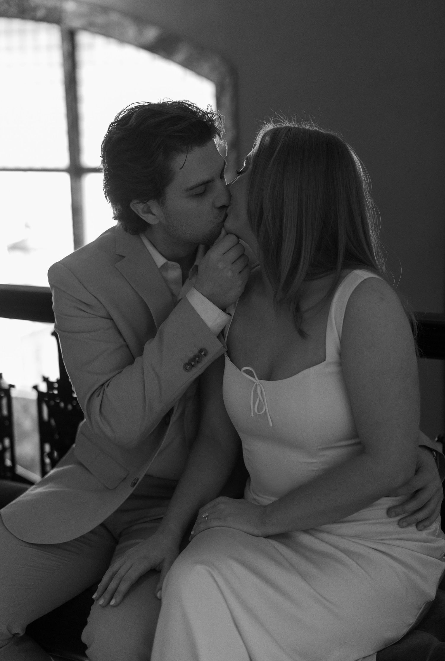 Black and white romantic photos capture tender moments between newlyweds.