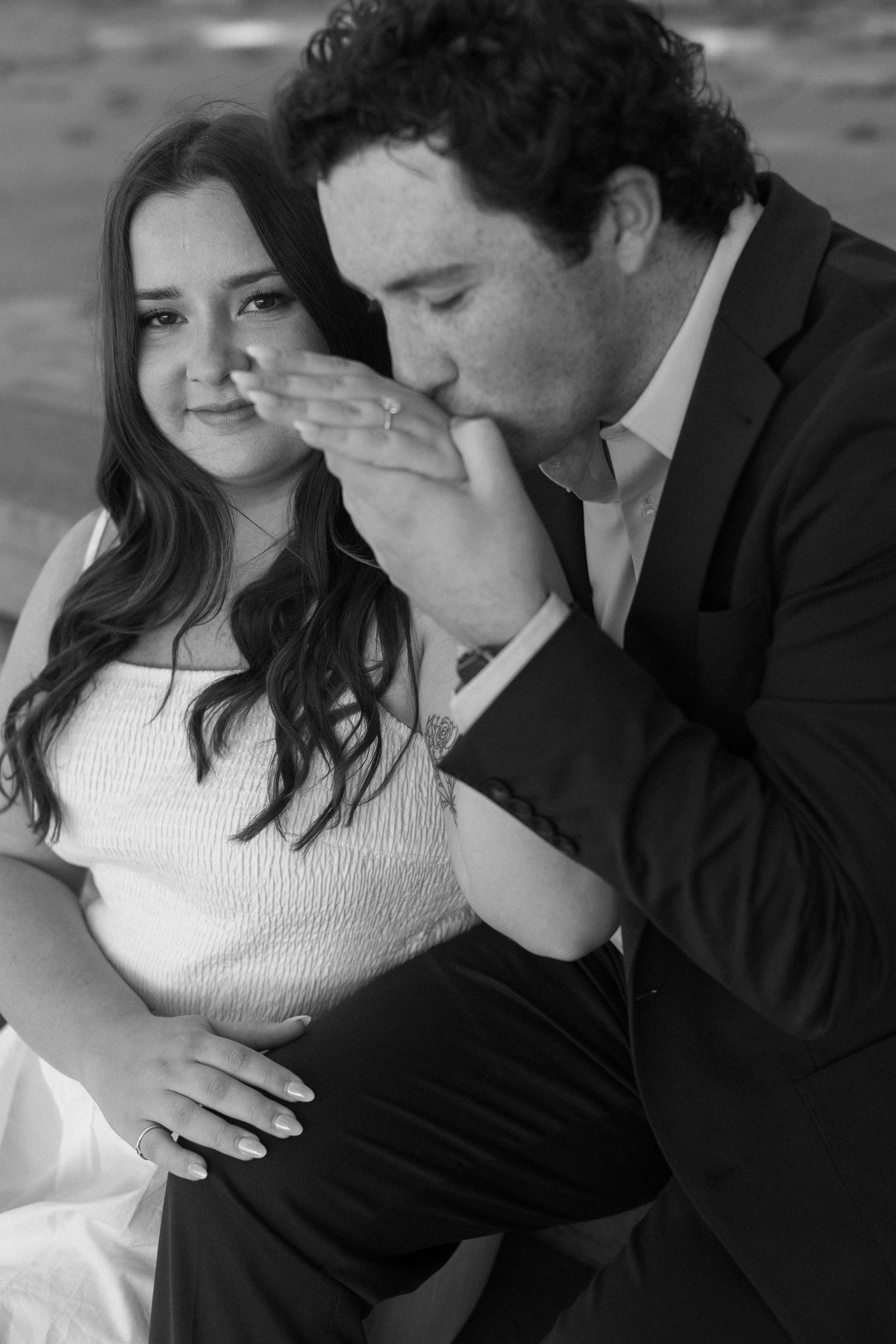 An intimate black and white portrait showing a tender moment between a couple.