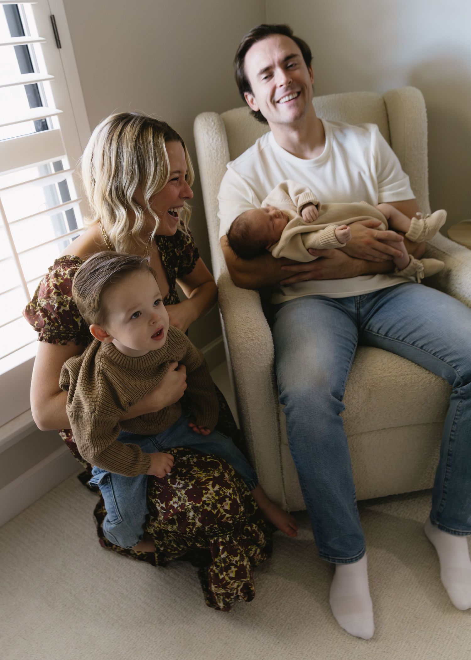 Candid moments of family bonding and laughter while relaxing on living room sofa.
