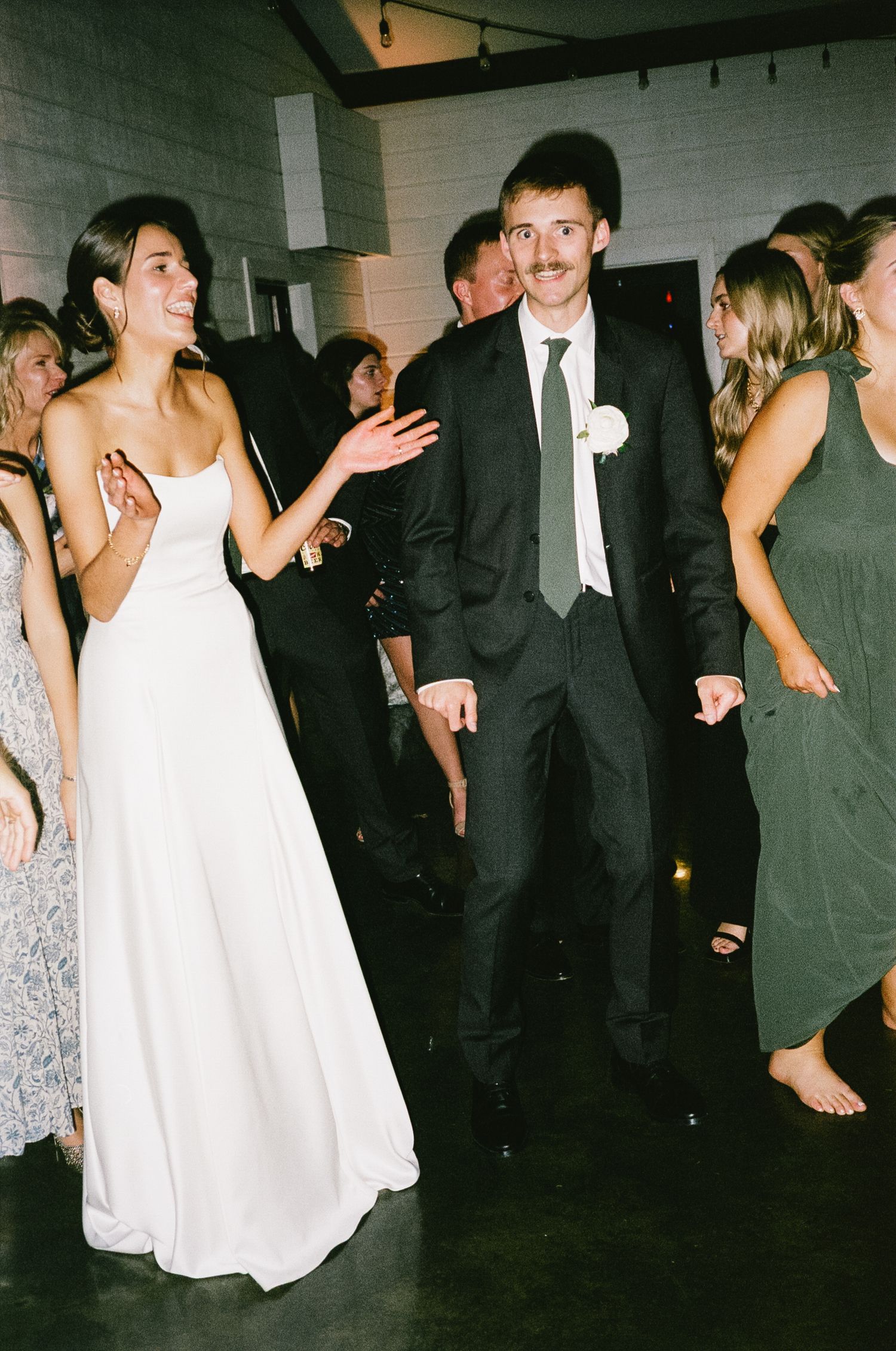 Wedding celebration on the dance floor with guests enjoying the festivities.