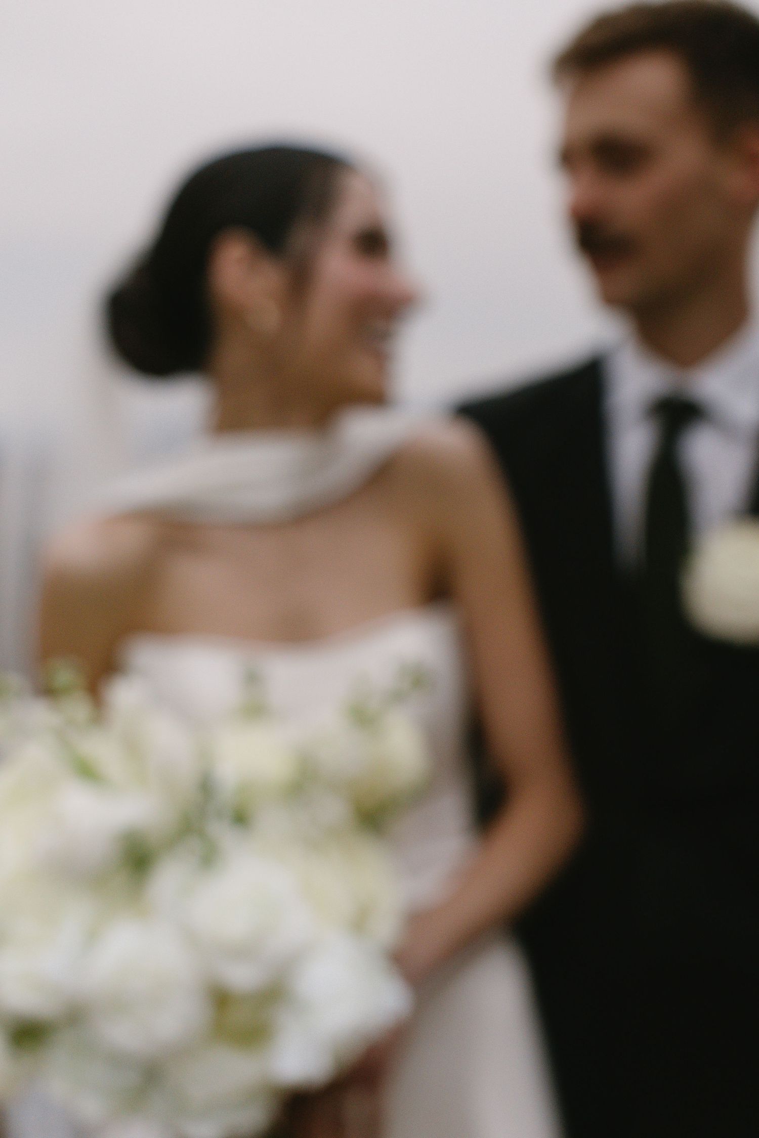 Elegant black and white wedding portrait series showing intimate moments between newlyweds.