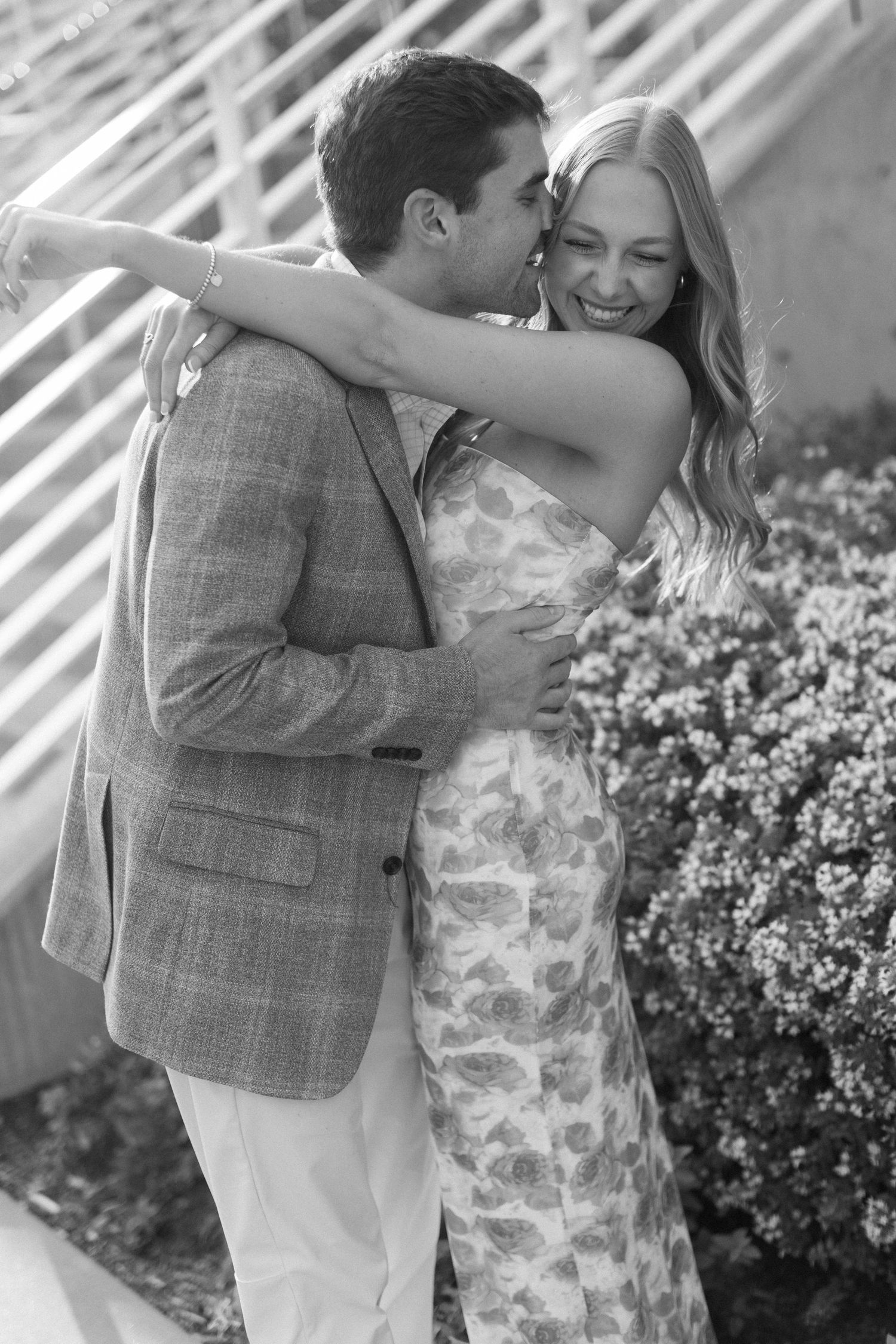 A romantic black and white photo series captures a couple sharing intimate moments outdoors.