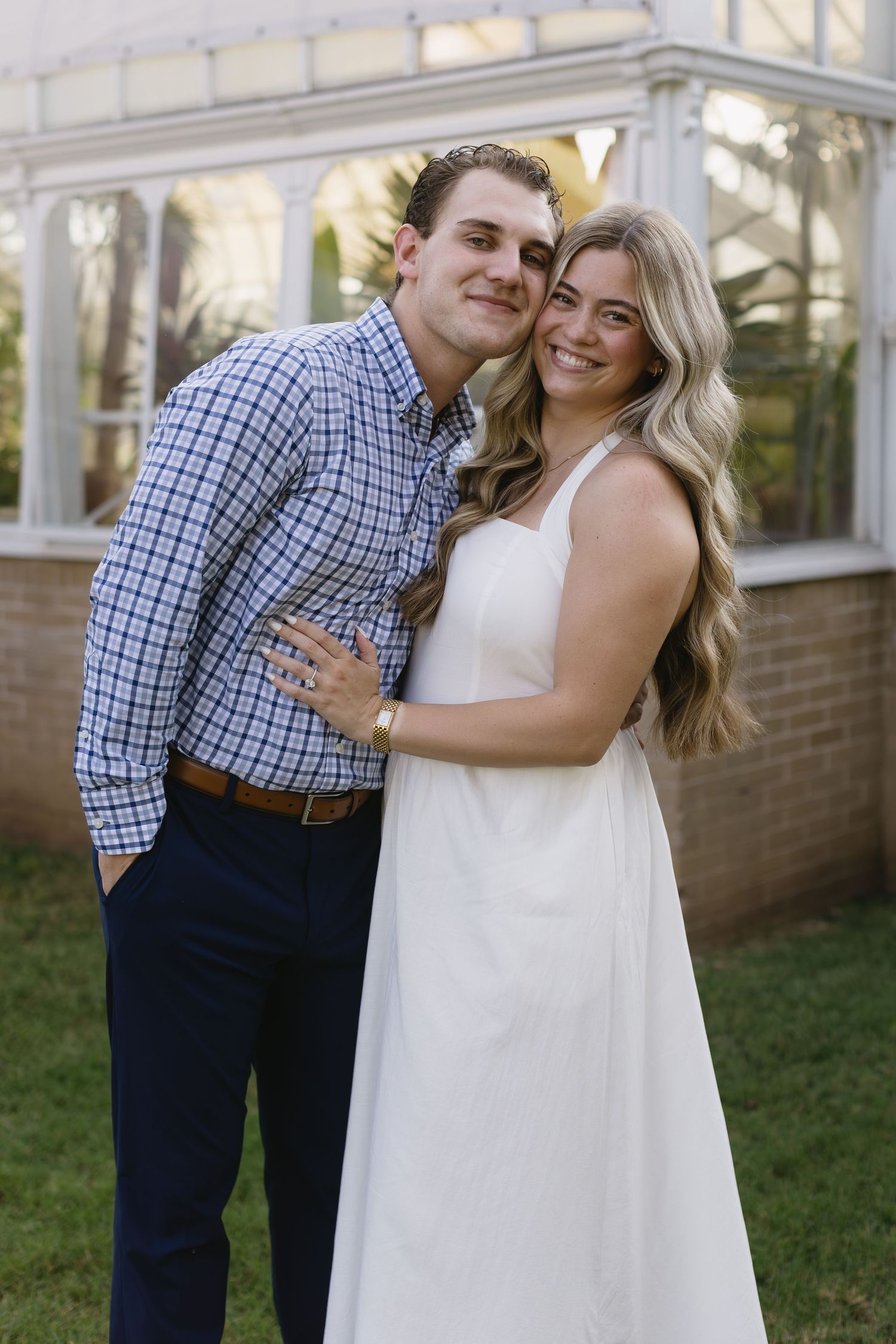 A sweet embrace captured in a sequence of photos against a brick building and greenery.