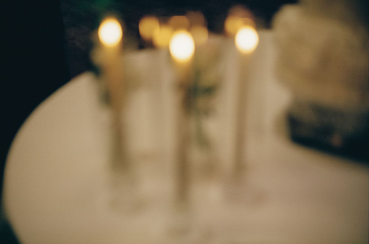 Soft focus wedding reception lighting creating warm bokeh effect.