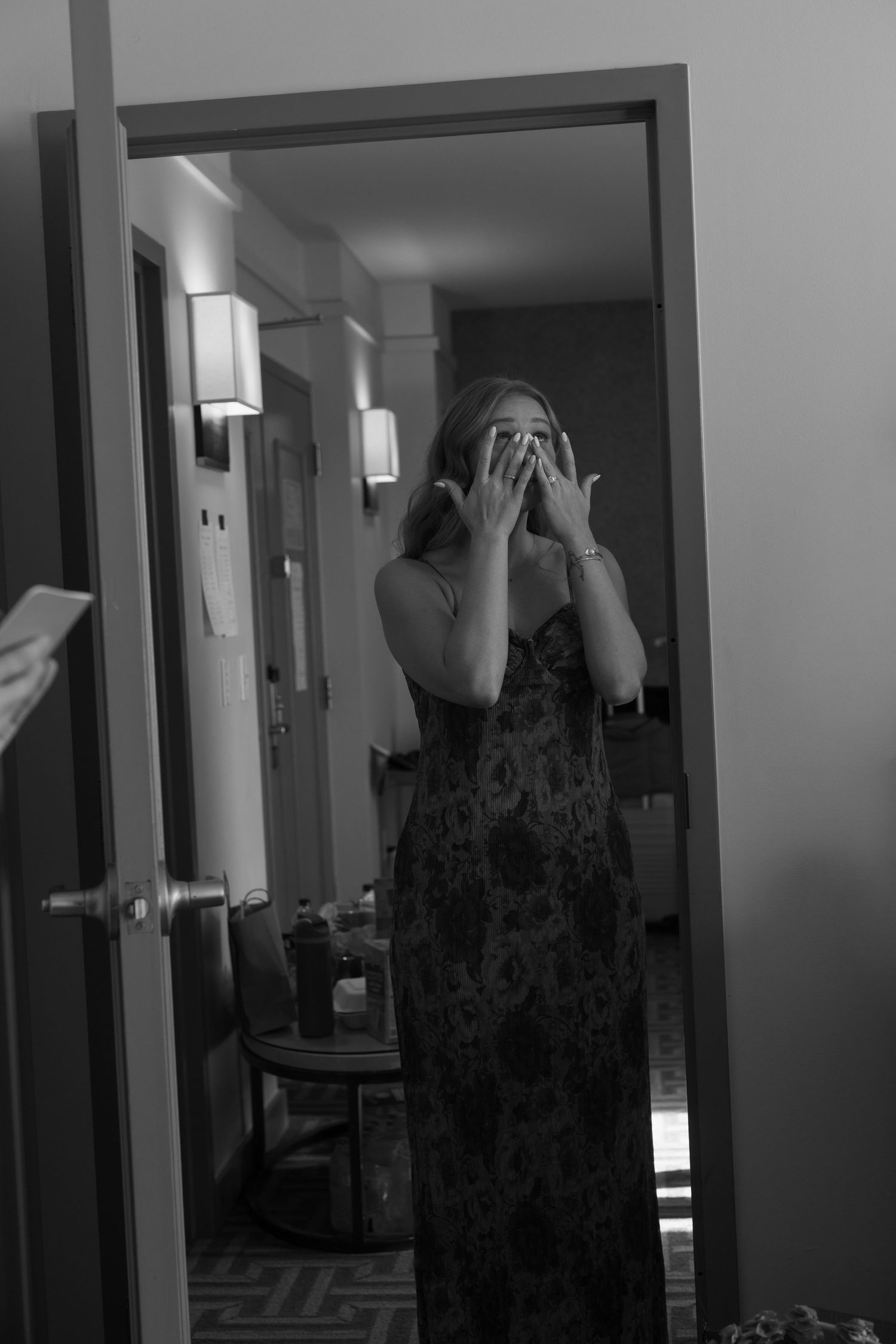 Artistic black and white mirror reflection showing a person in a patterned dress.