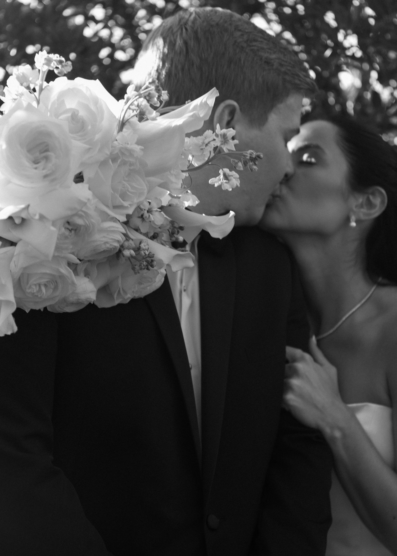 Black and white sequence of a romantic moment with white floral bouquet.