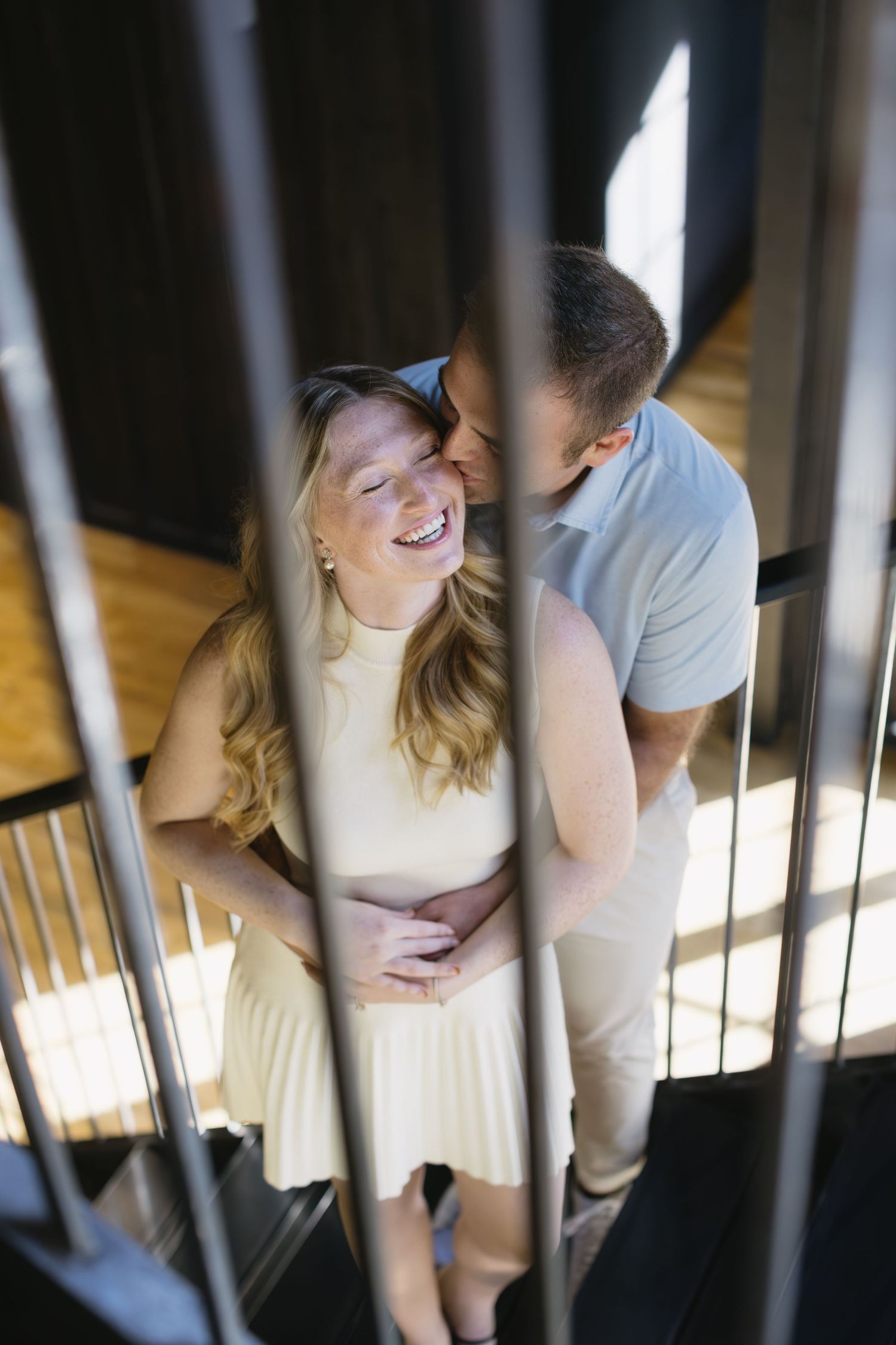 Artistic photo series of a couple sharing intimate moments through wooden slats.