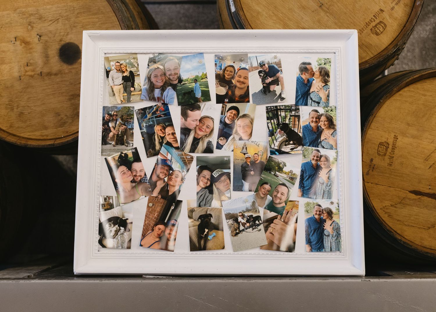 A series of photo prints laid out in a row on a wooden surface with wine barrels visible in the background.