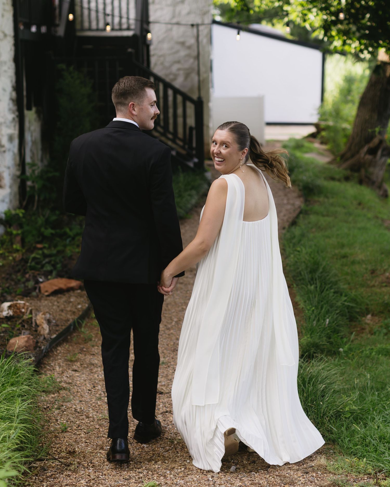 Artistic black and white photos showing close-up details of wedding attire from behind.