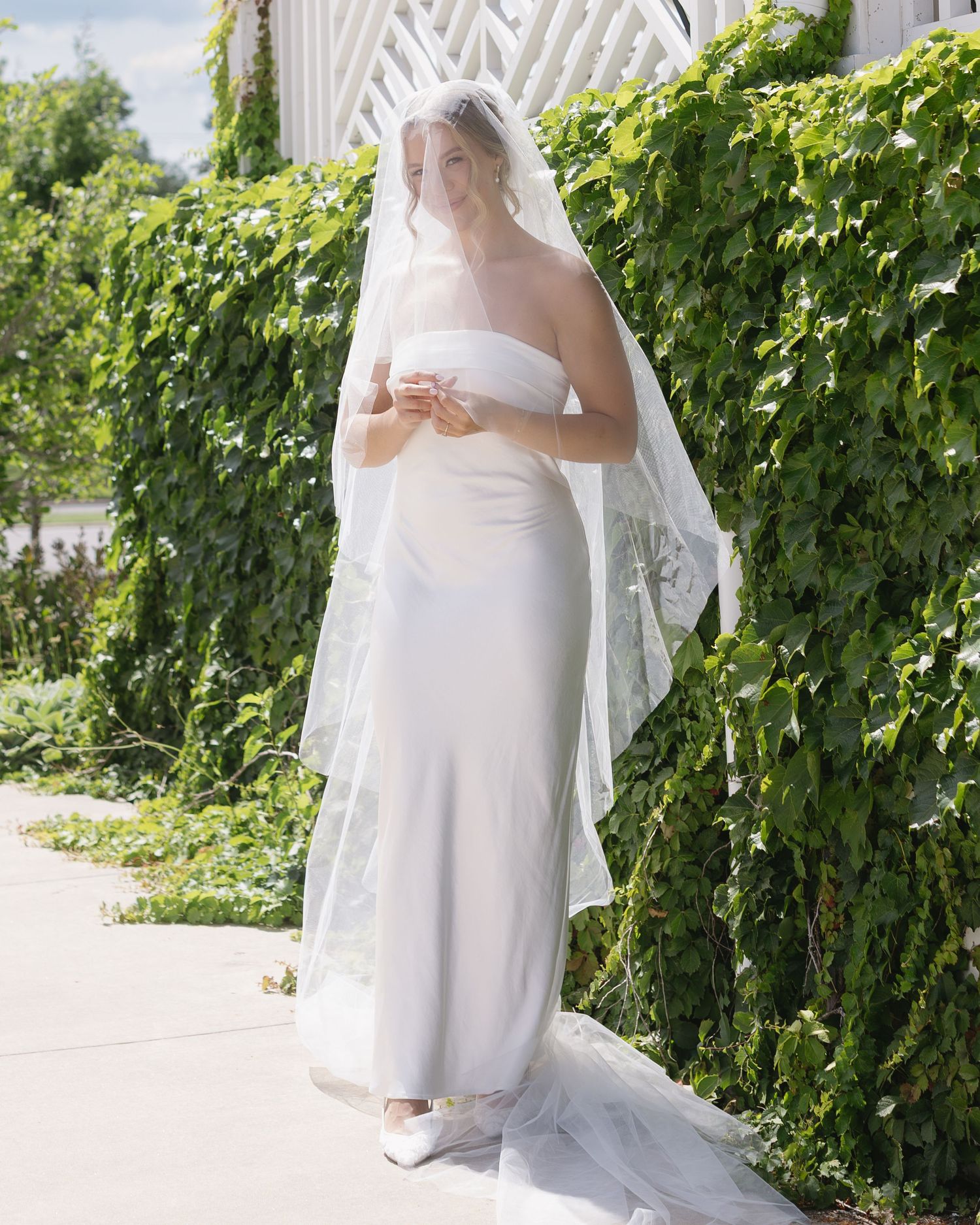 A sequence of bridal portraits showing a white wedding dress and veil against an outdoor backdrop with green foliage.