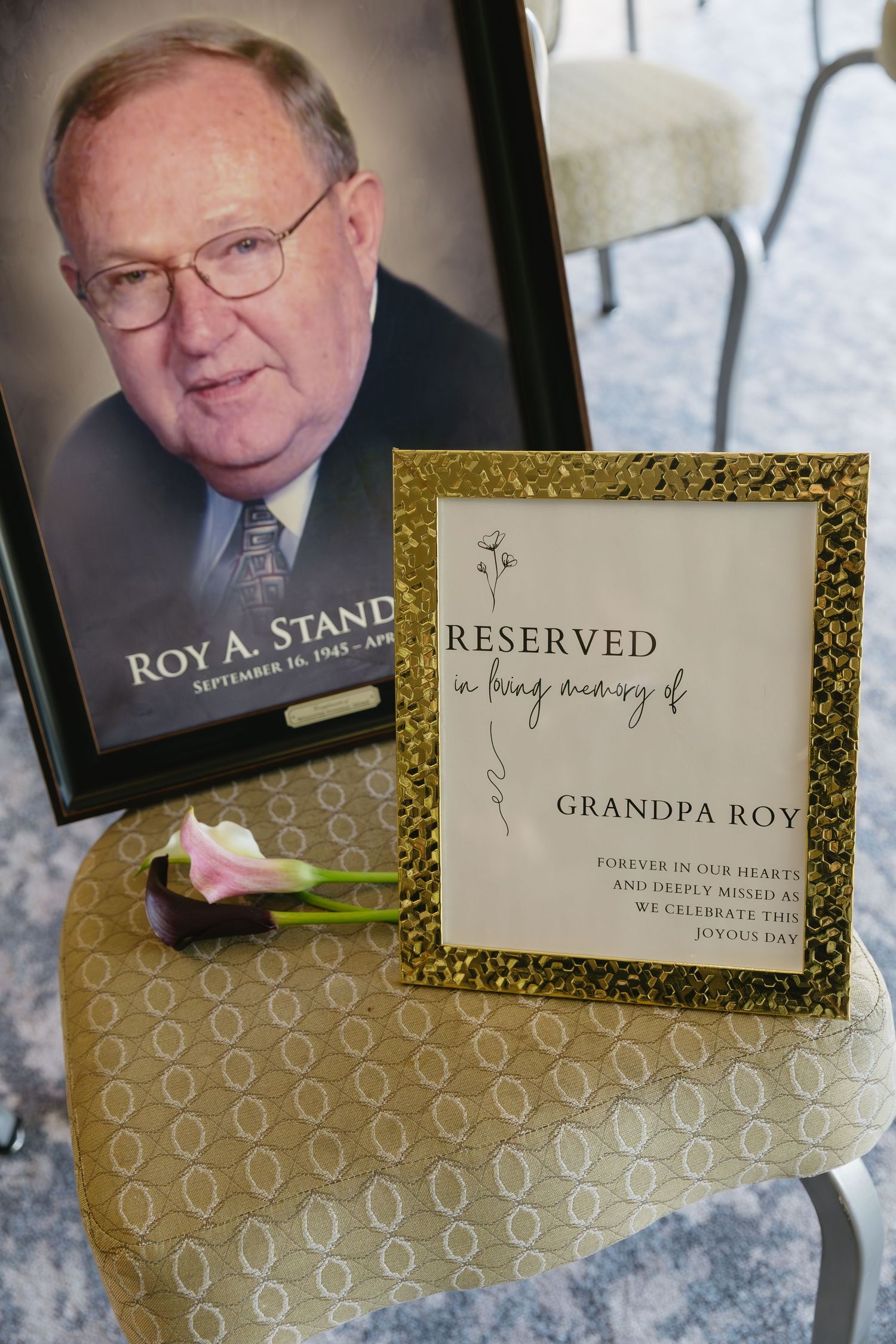 Memorial place card with 'Reserved' text and photo displayed on textured gold paper.