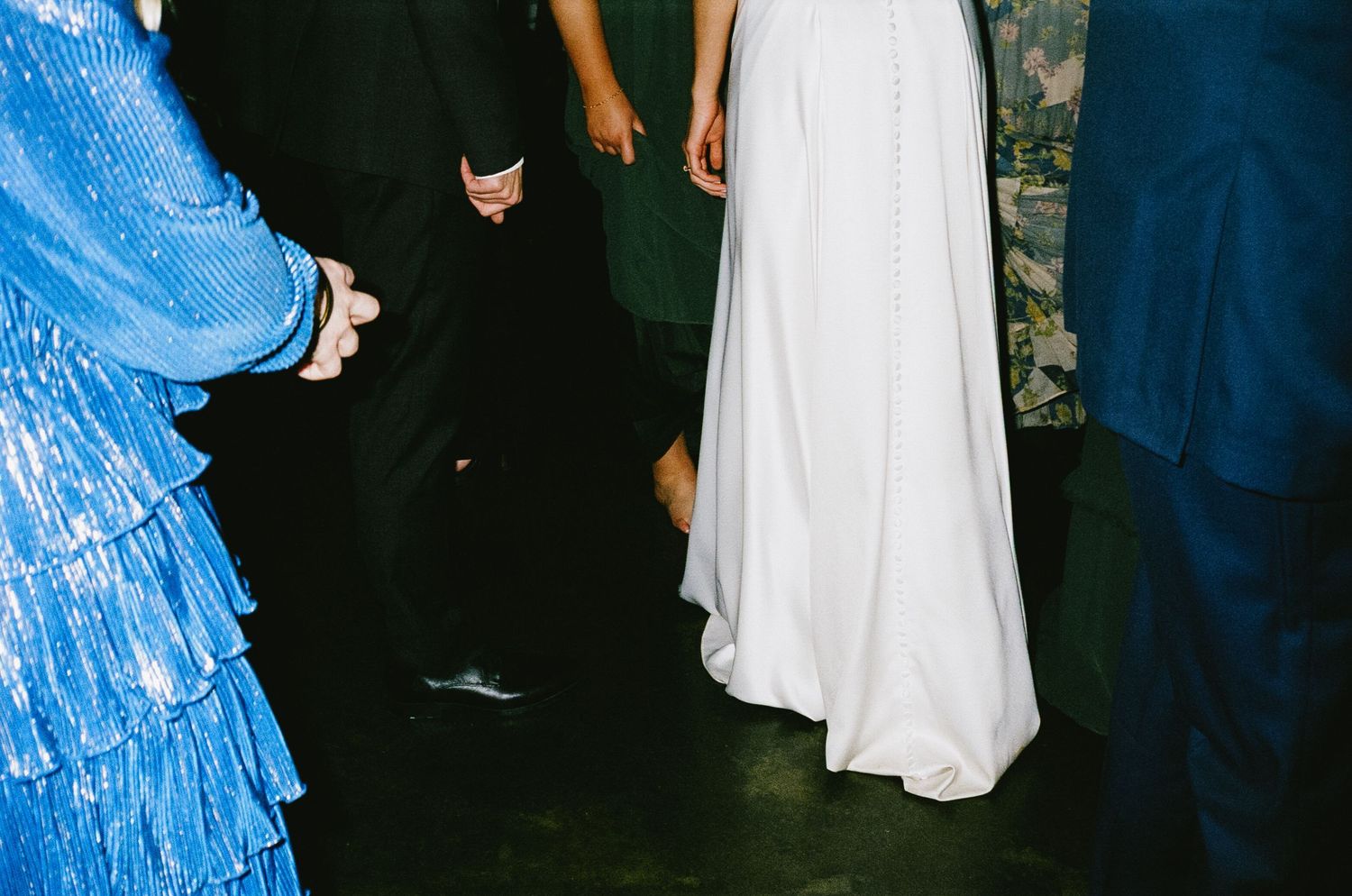 Wedding reception dance floor showing formal dresses and shoes.