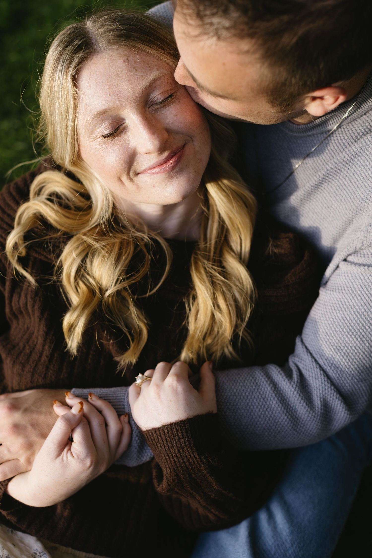 Close-up shots of couple sharing tender moments in casual sweaters.