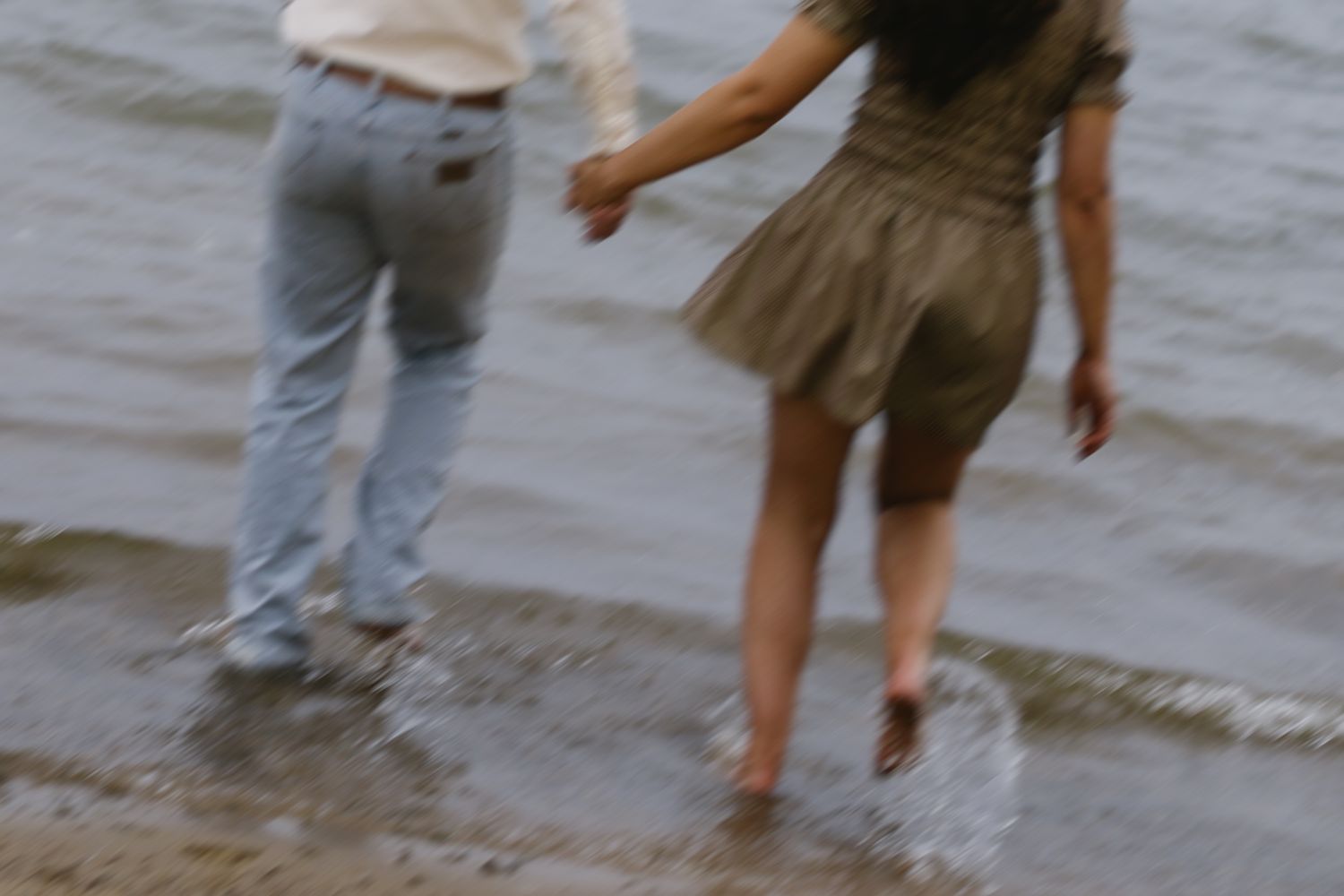 Candid shots of feet and legs splashing in ocean water.