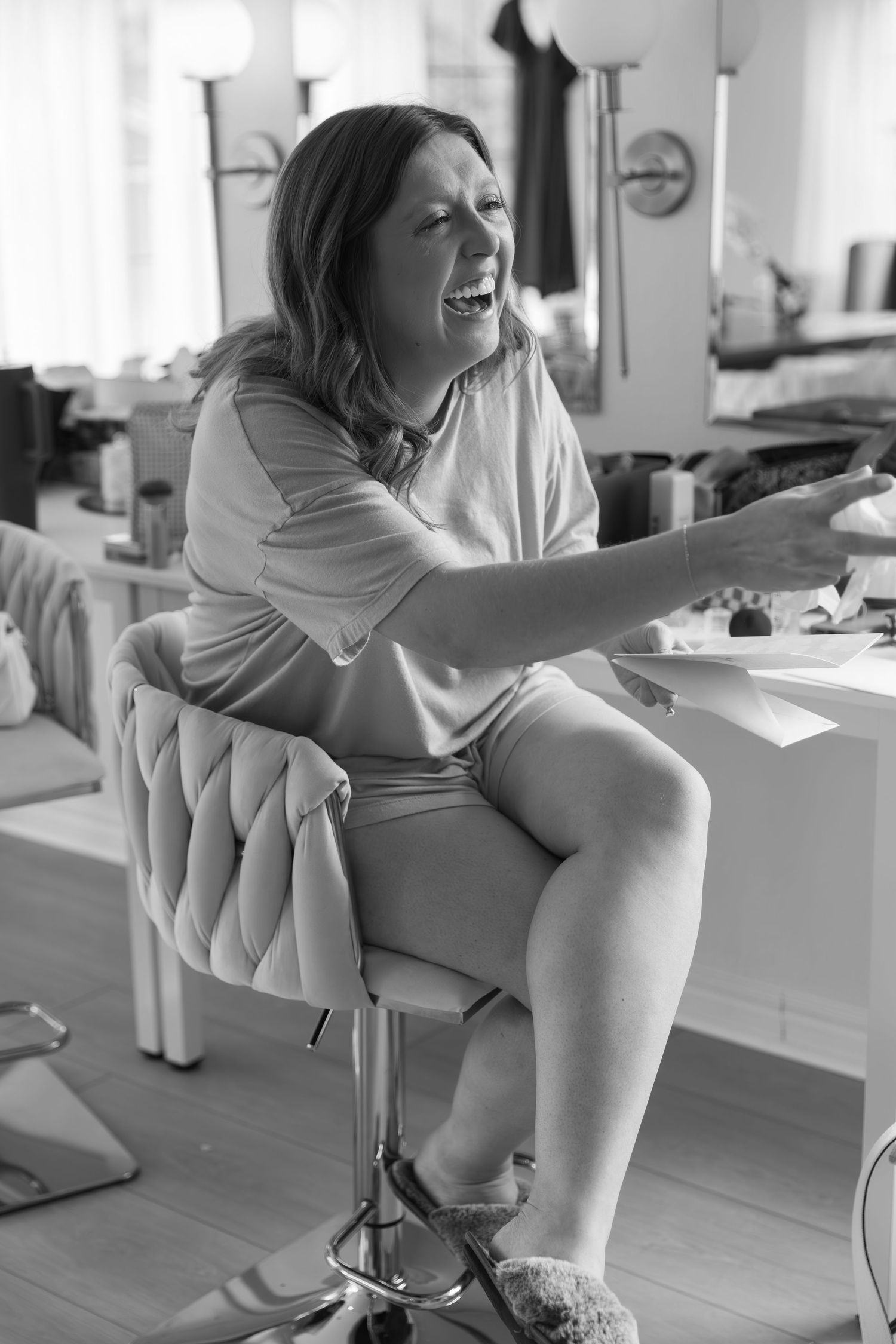 Getting ready sequence showing a tufted chair against a light hardwood floor in black and white.