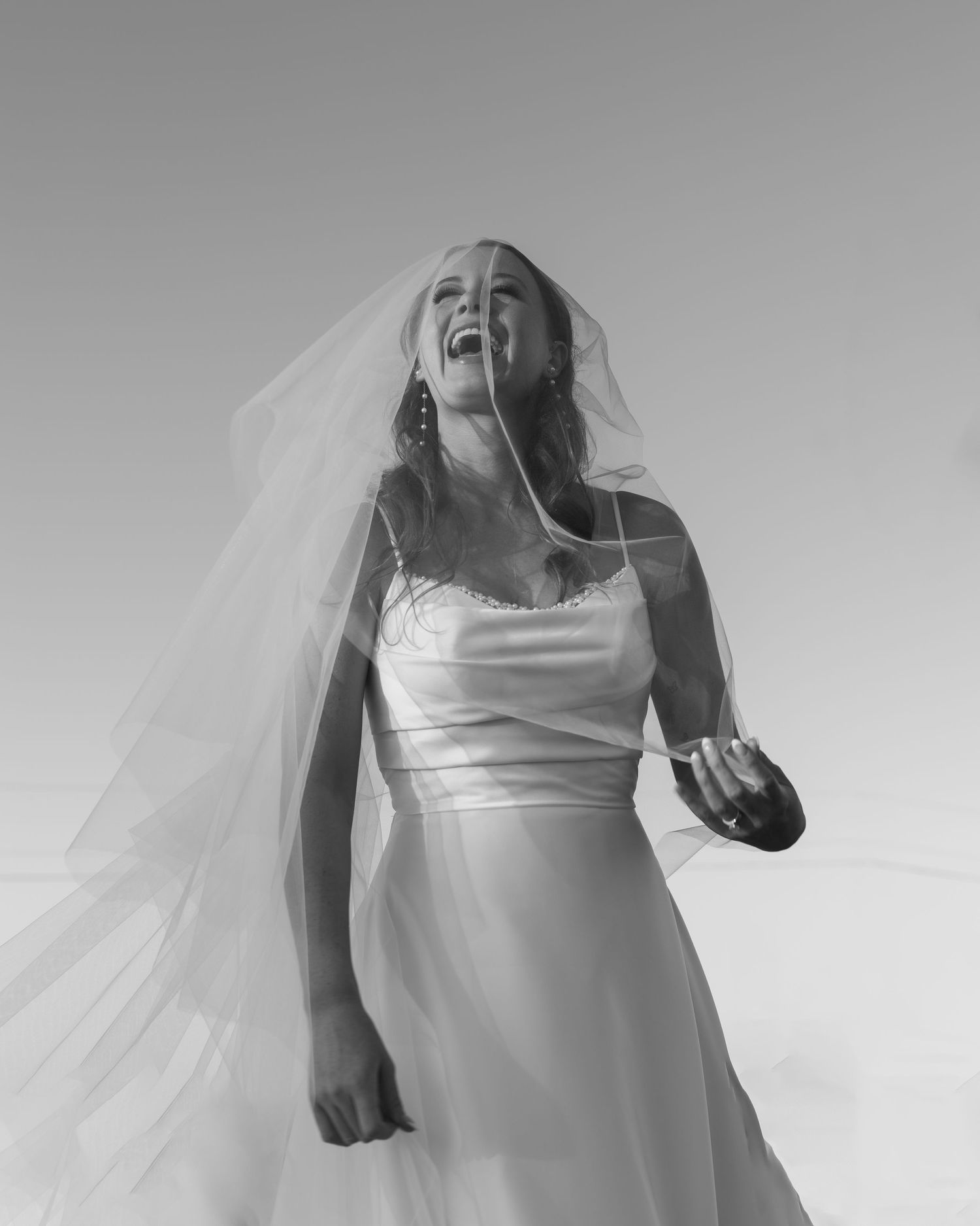 Candid black and white shots show energetic movement and flowing white fabric creating dynamic silhouettes.