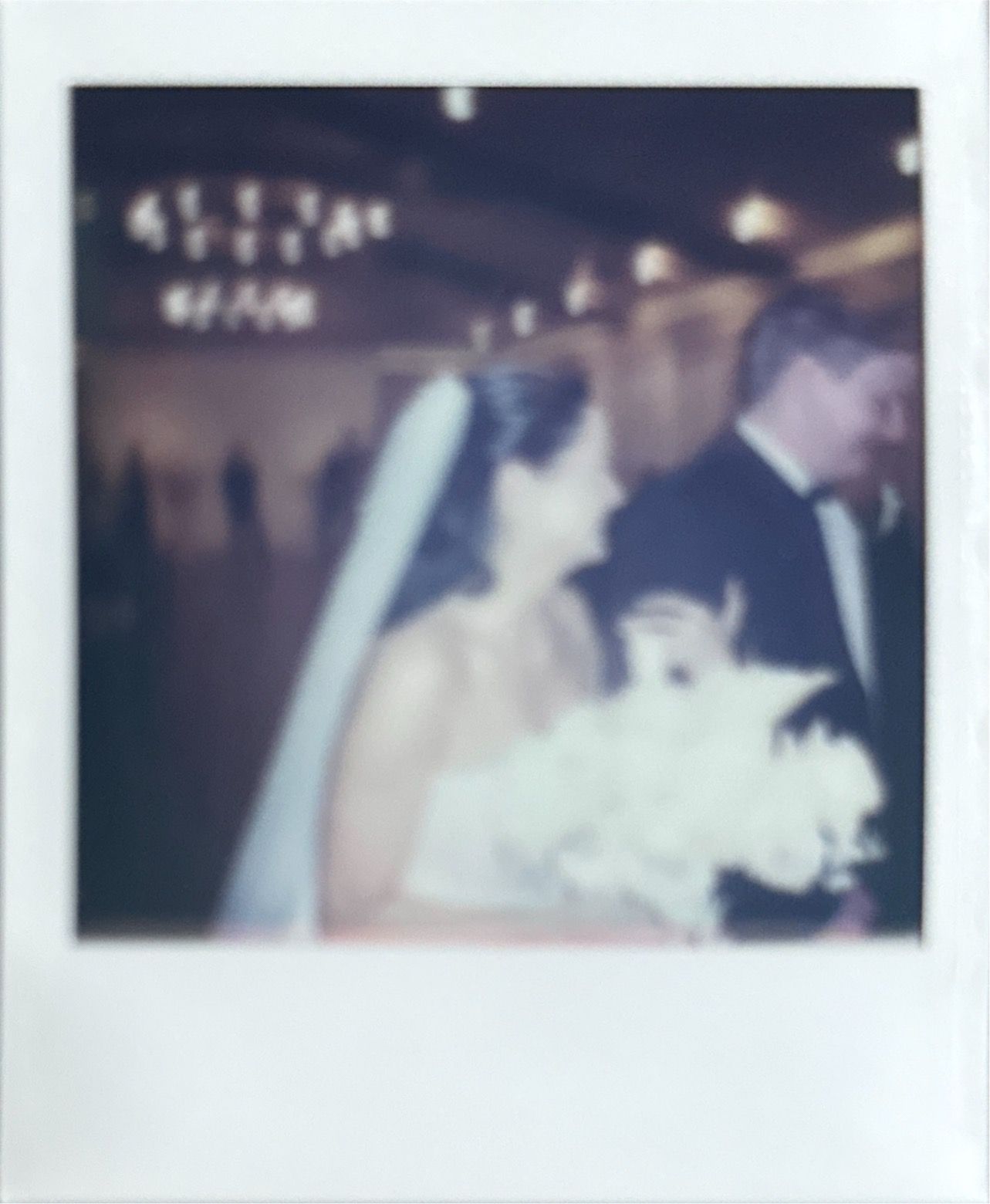 Vintage polaroid photo capturing a romantic wedding moment.