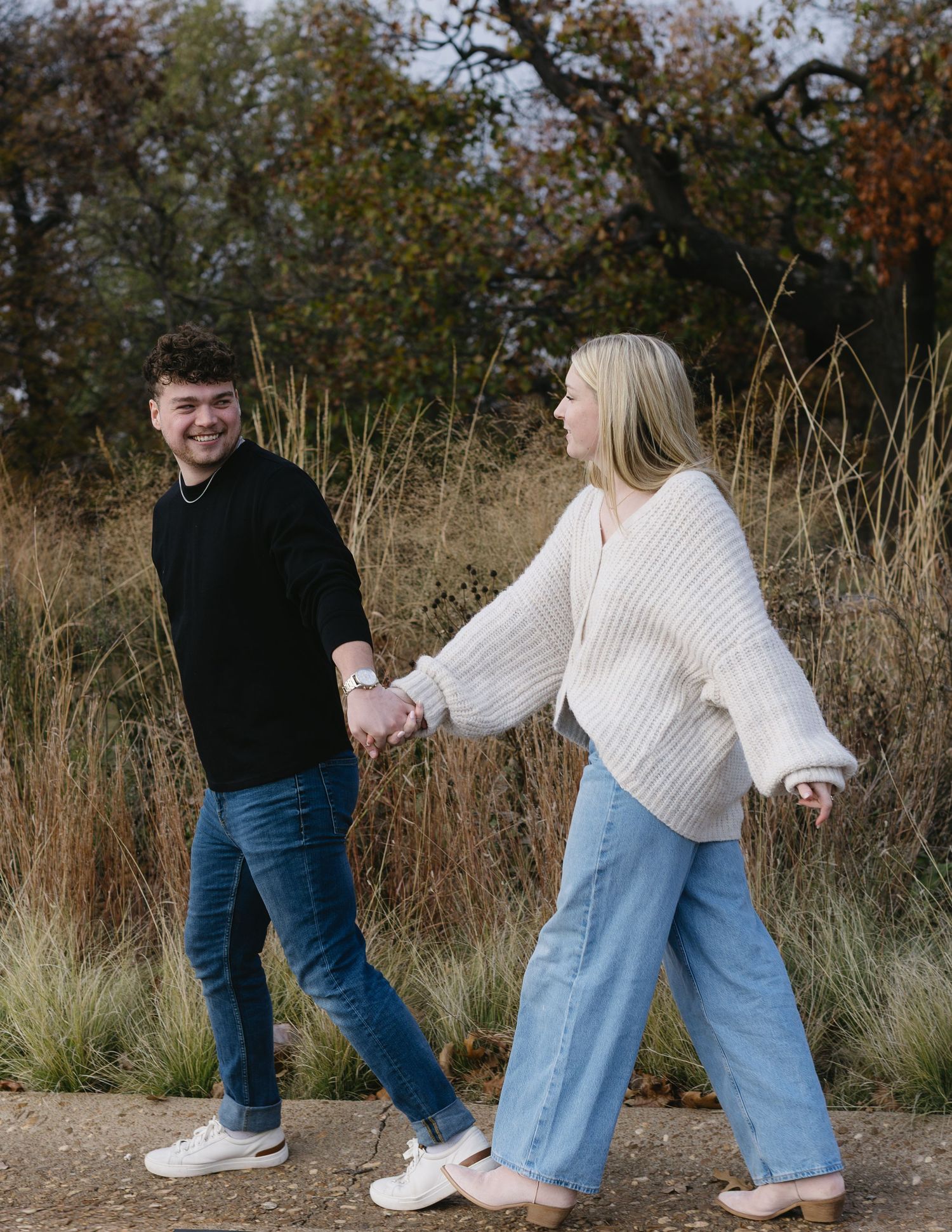 A playful sequence of dance moves between two people in jeans and sweaters against an autumn field background.