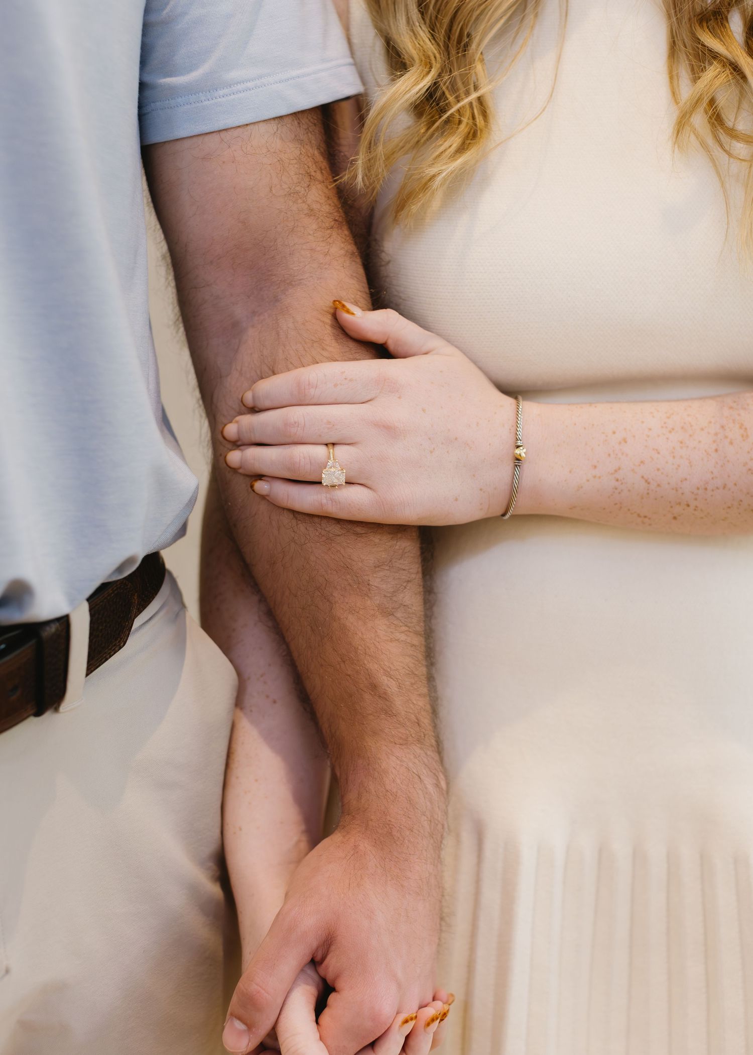 Close-up detail shots of hands and engagement ring in soft natural lighting.