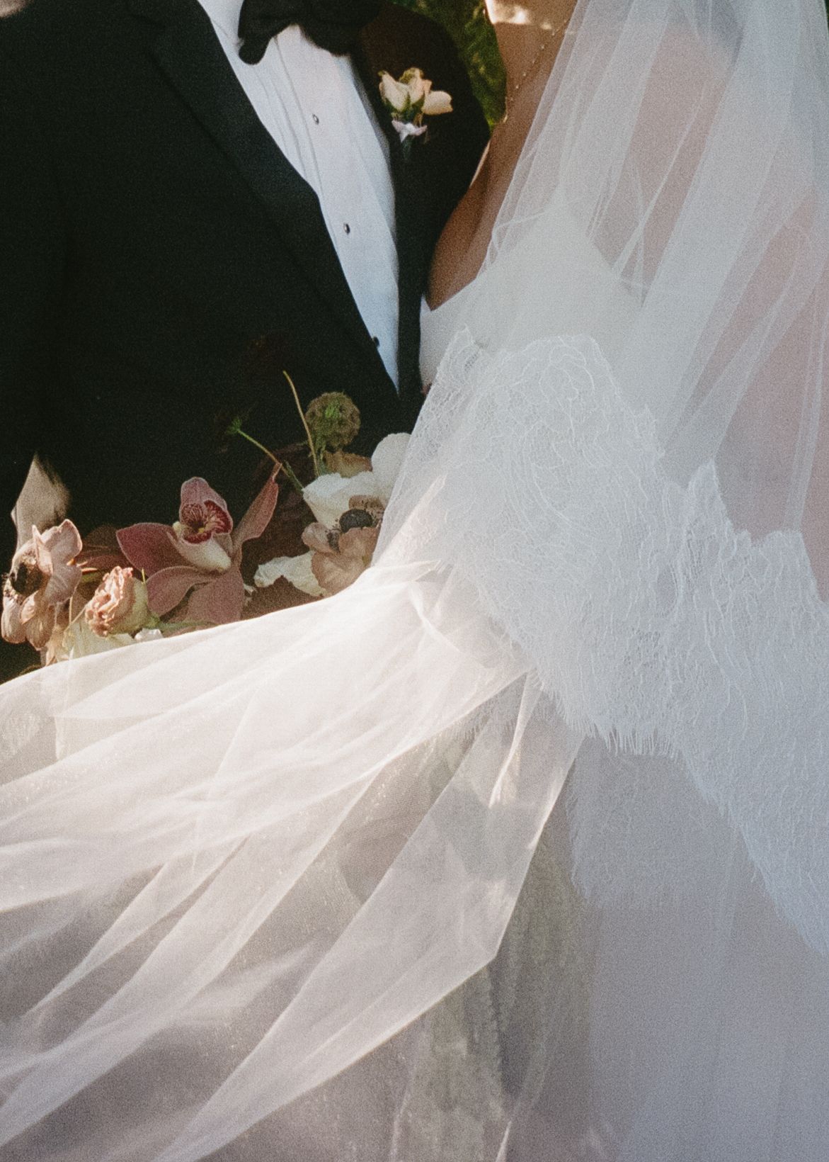 Close-up detail of flowing white tulle wedding veil with delicate fabric texture.