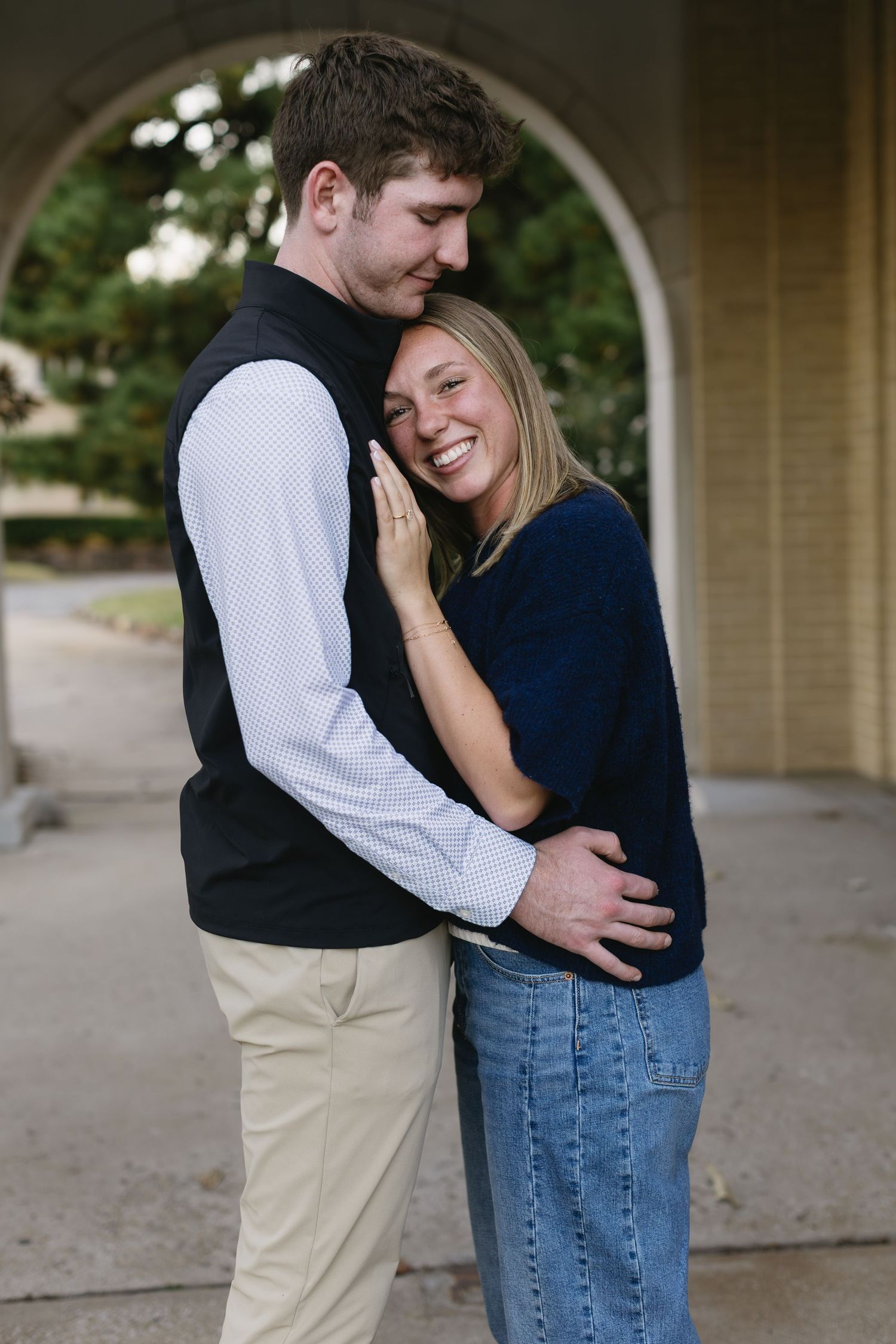 Sweet candid moments of a couple sharing laughter and embraces during an outdoor photoshoot.