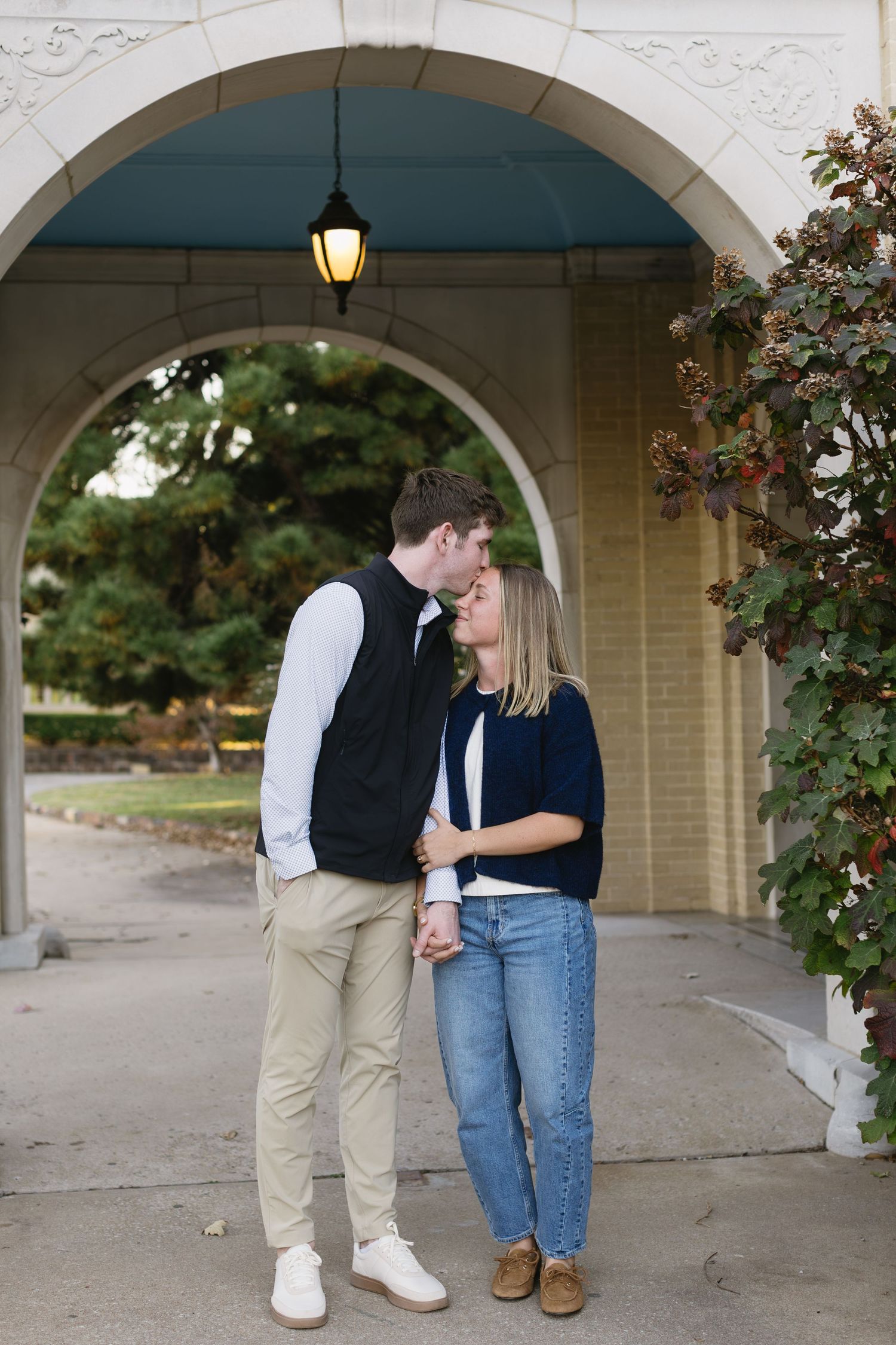 A romantic scene under white arched walkway with climbing roses.