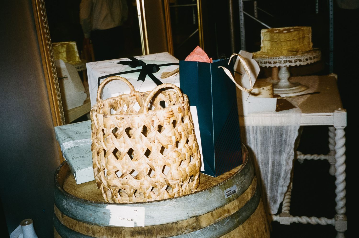 Decorative woven basket-style wedding cake displayed on a rustic wooden surface.
