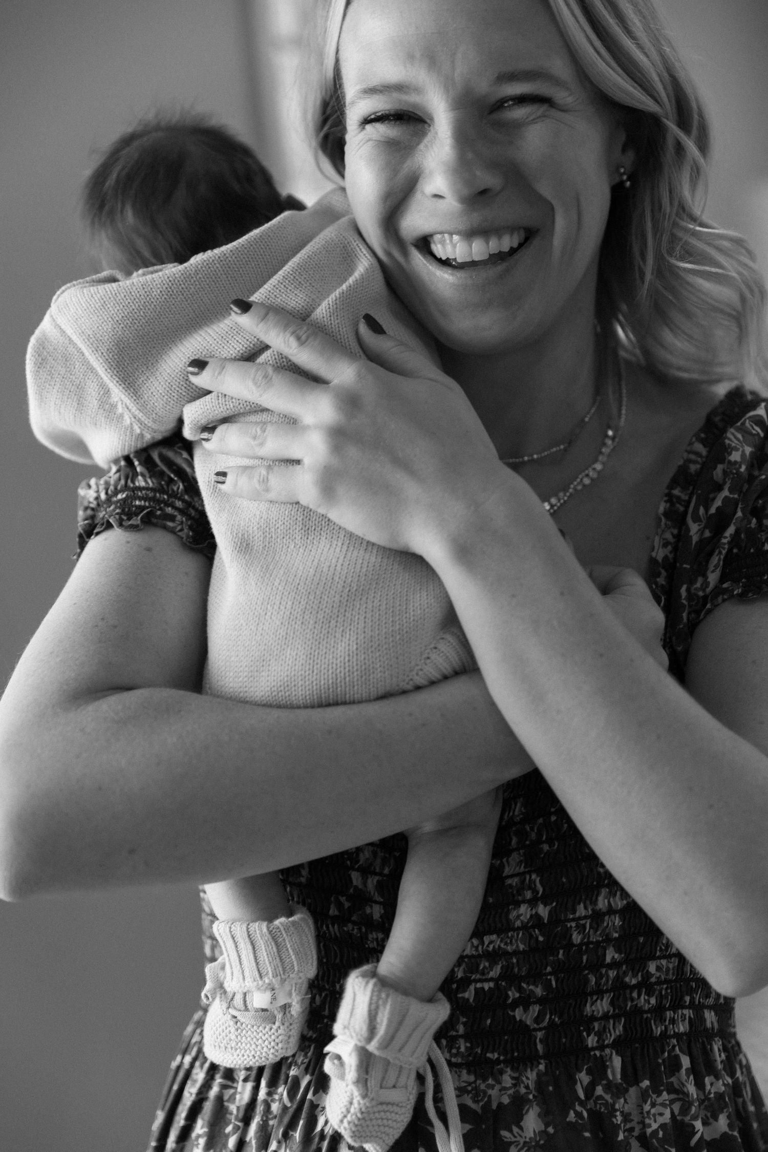Black and white series of joyful moments between parent and baby.