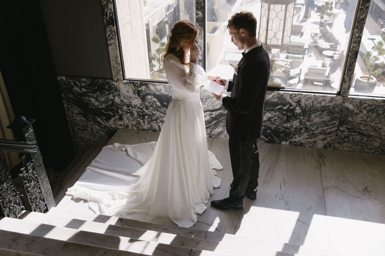 Intimate wedding ceremony moment captured in natural window light.