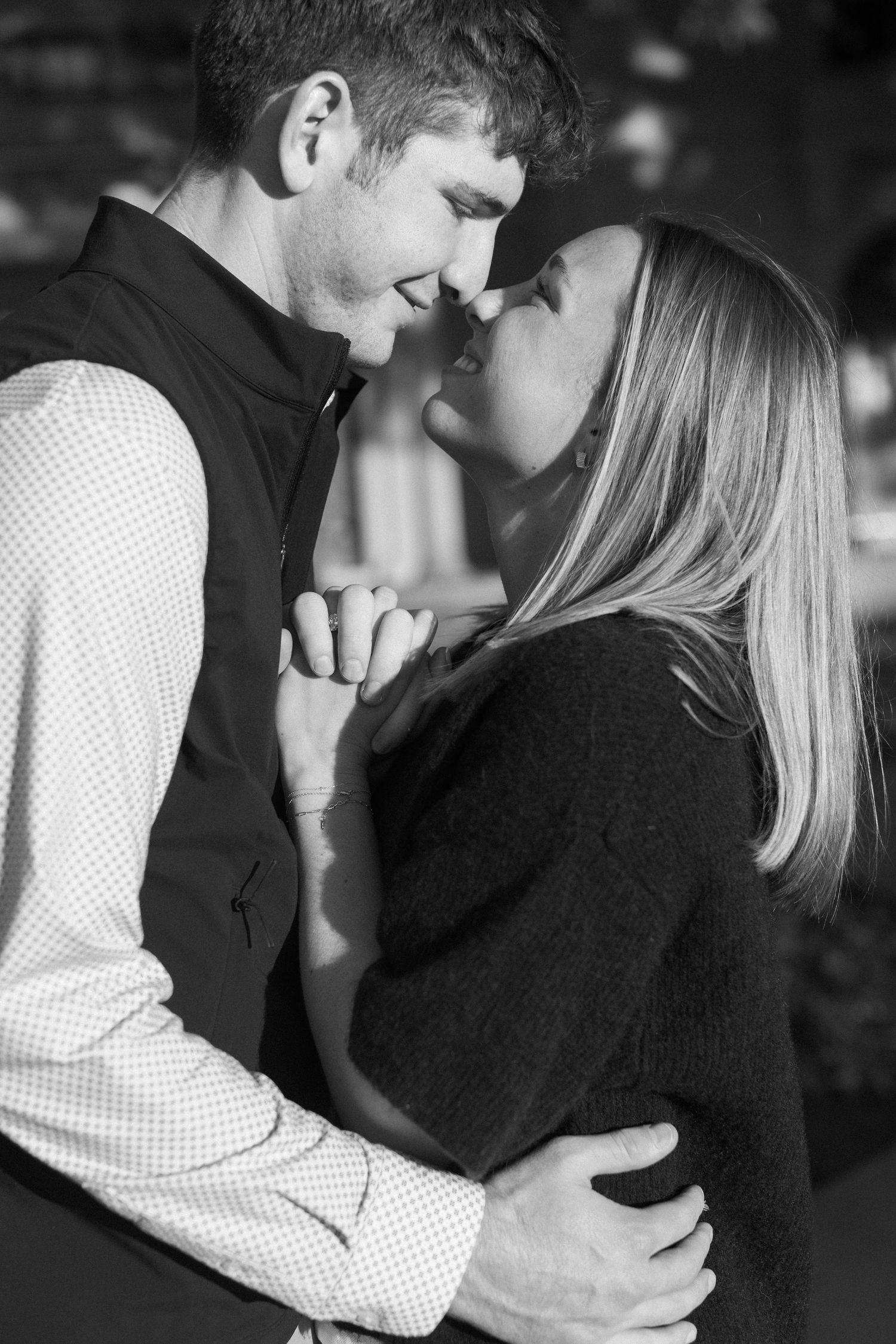 Black and white photo sequence capturing intimate moments between a couple in casual attire.