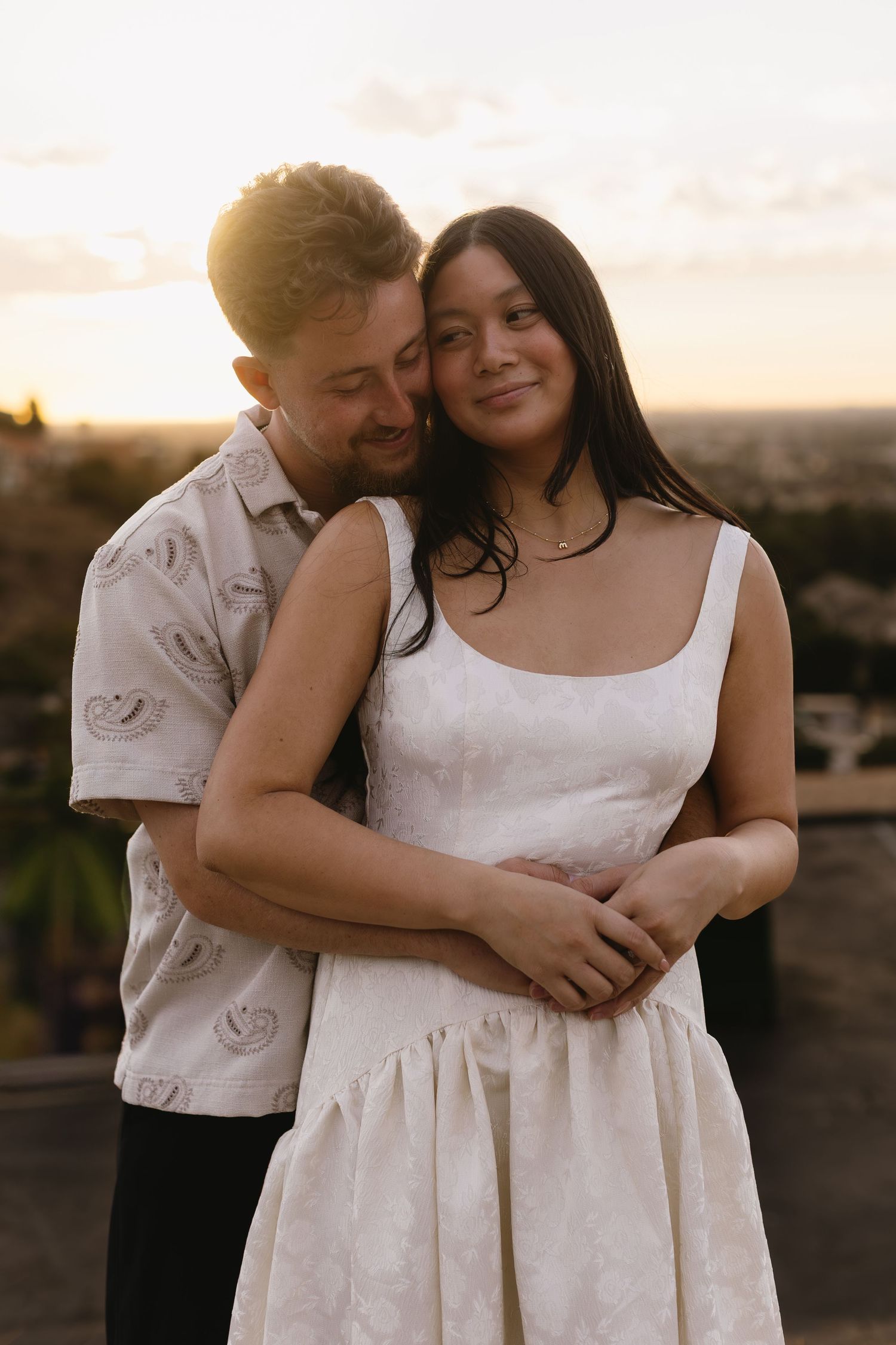Intimate couple's portrait session during sunset with soft natural lighting.