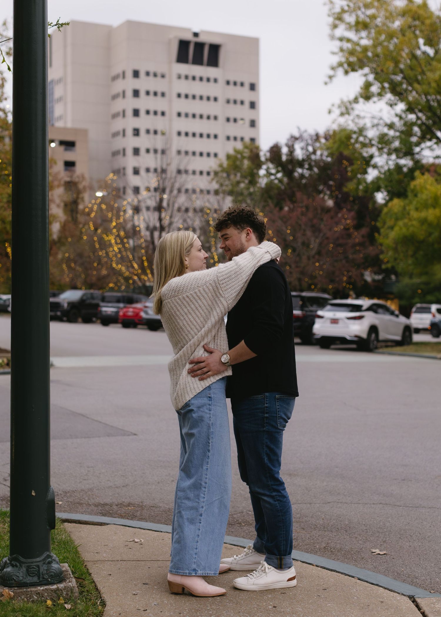 A sweet moment shared between two people in a parking lot.