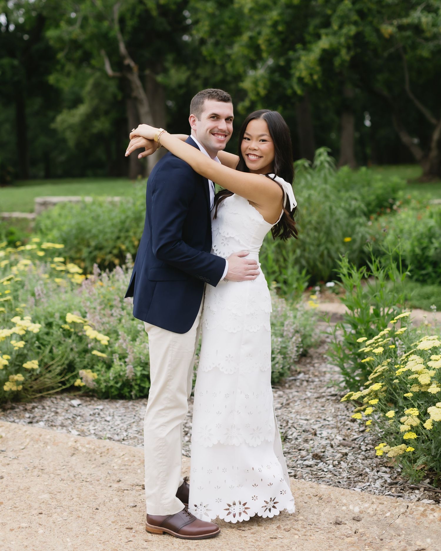 Candid wedding photo series in a garden setting with yellow flowers and natural landscaping.