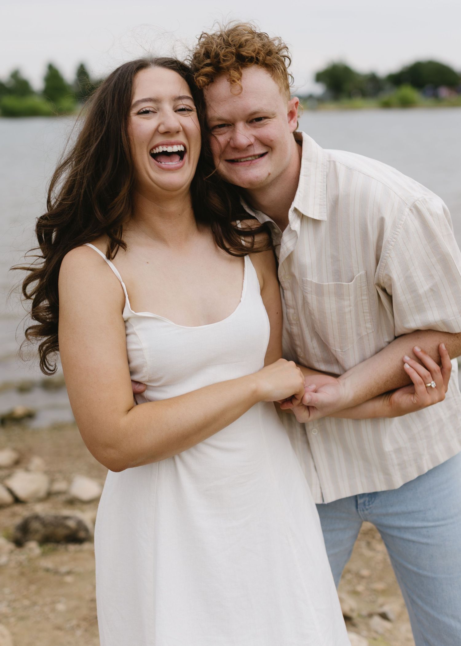 Candid sequence of a couple laughing together during a lakeside photoshoot.