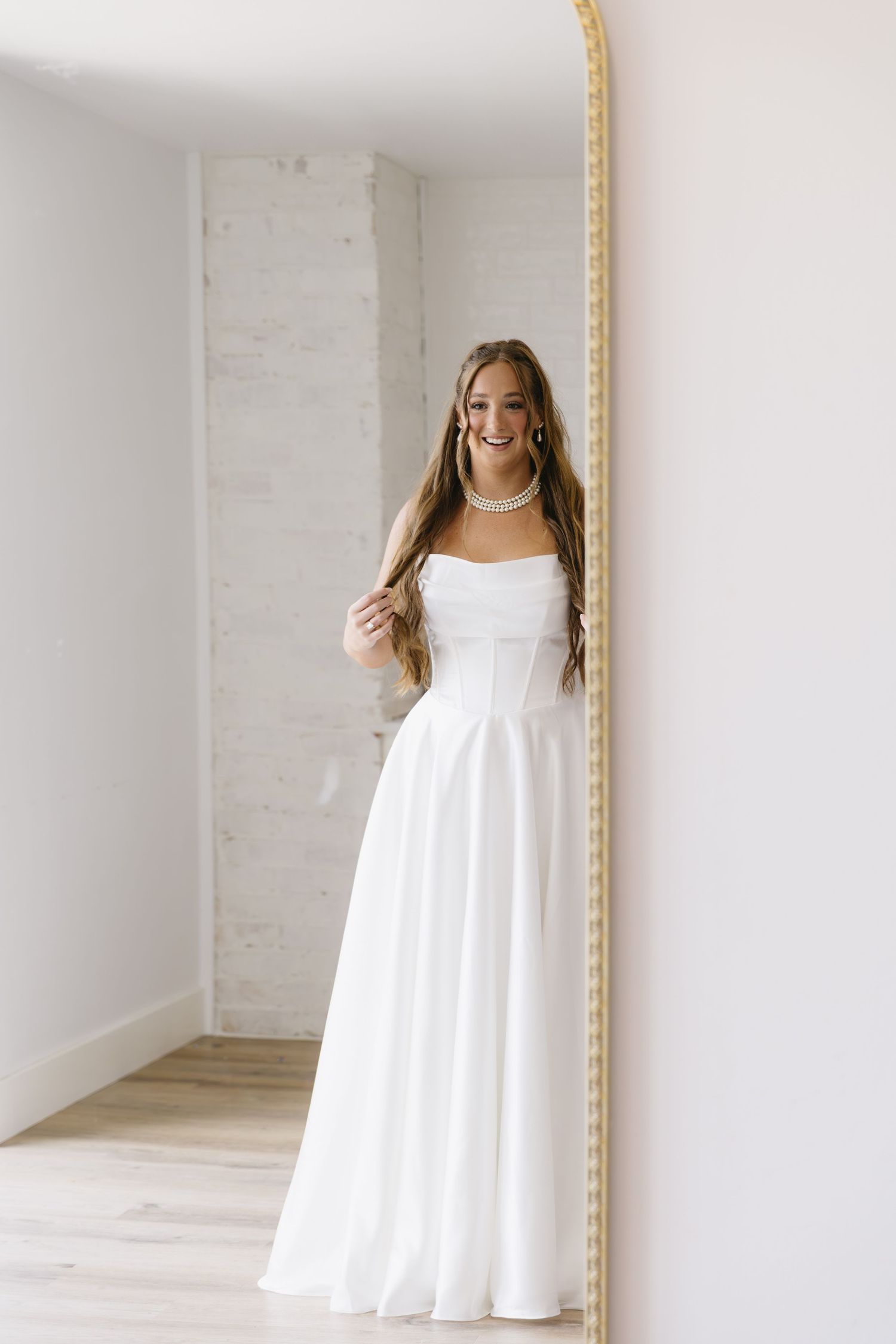 Series of bridal portraits in a white room with a decorative gold mirror.