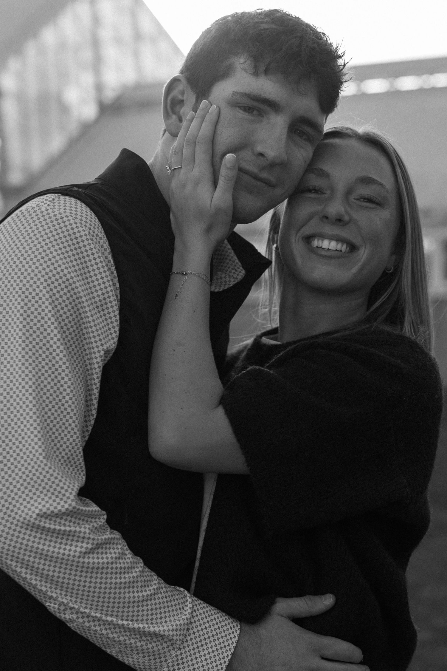 Black and white intimate portrait of a couple sharing a joyful moment.