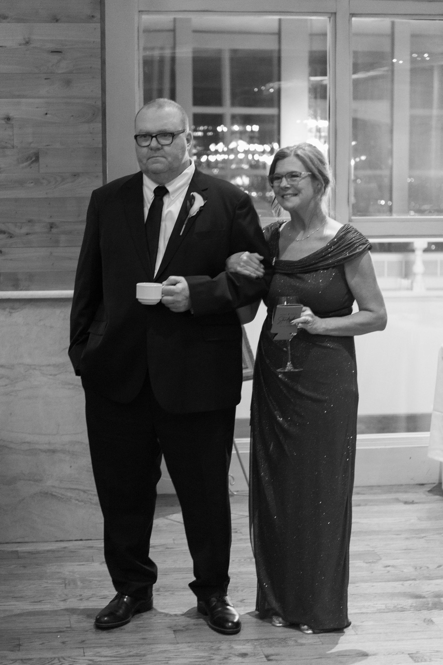 Black and white photo of guests enjoying drinks at a formal event.