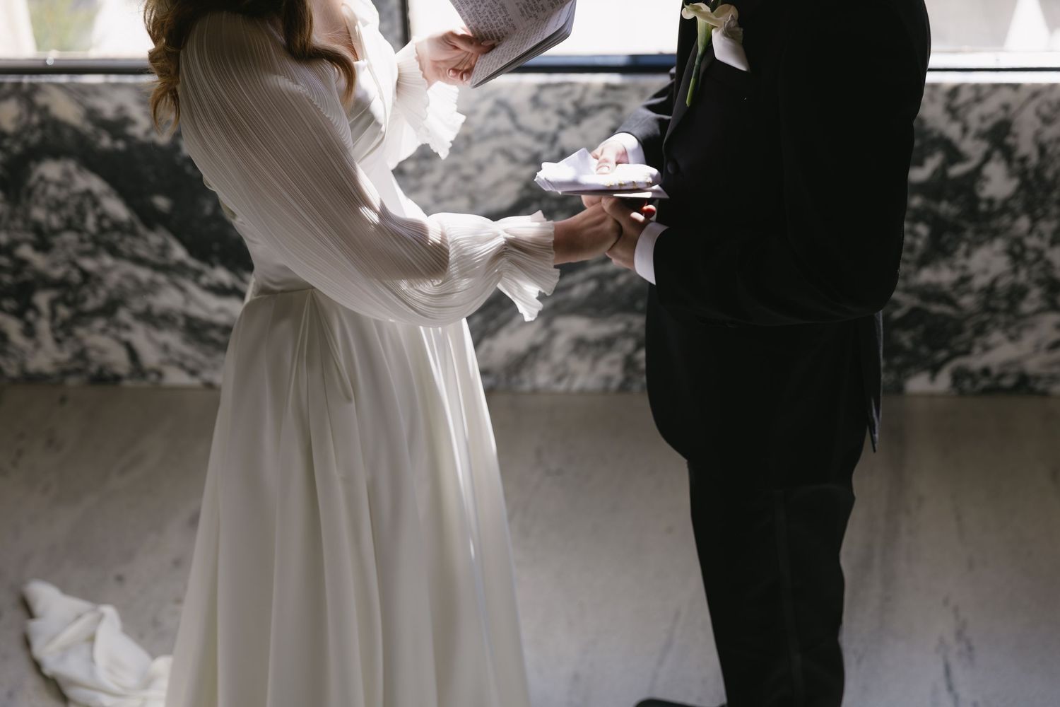 Artistic black and white shot of wedding couple in silhouette.