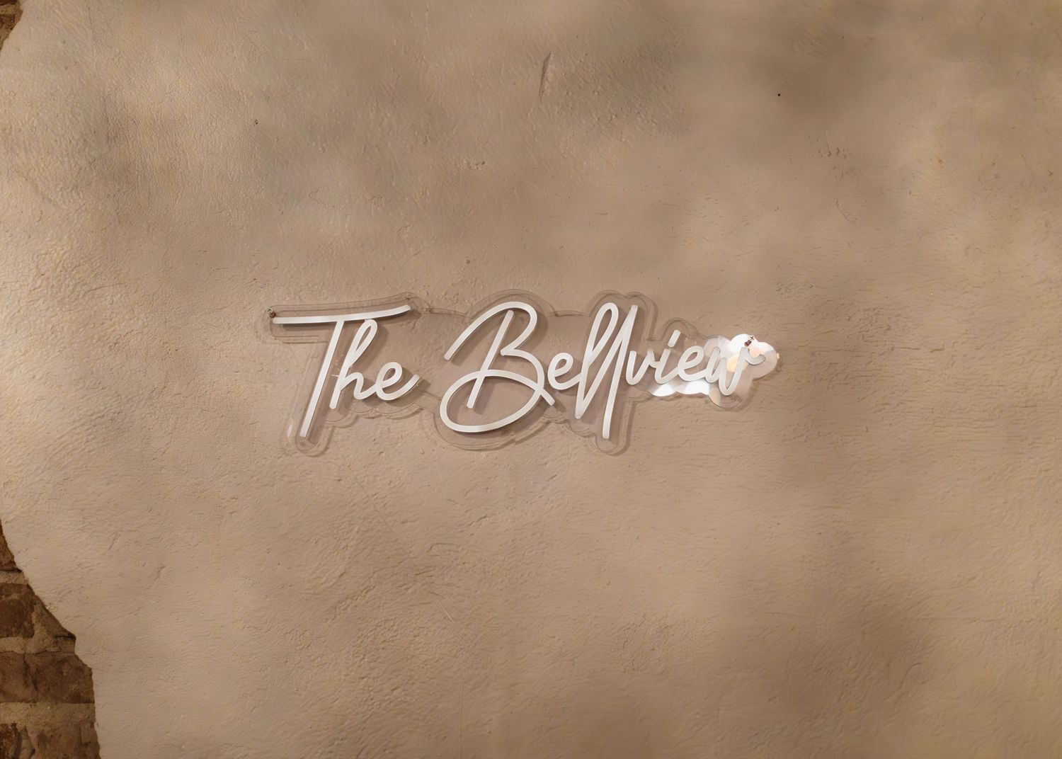 A vintage sepia-toned collage of architectural elements and decorative text showing The Bellezza signature.