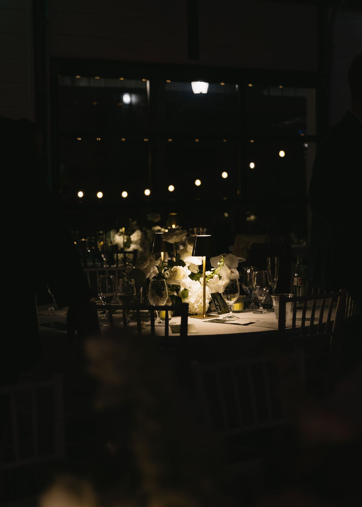 Dark reception venue with string lights creating ambient atmosphere.