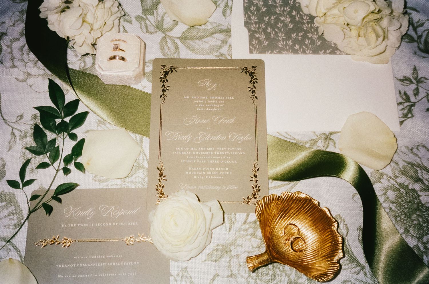Wedding invitation suite with cream roses and gold foil details.